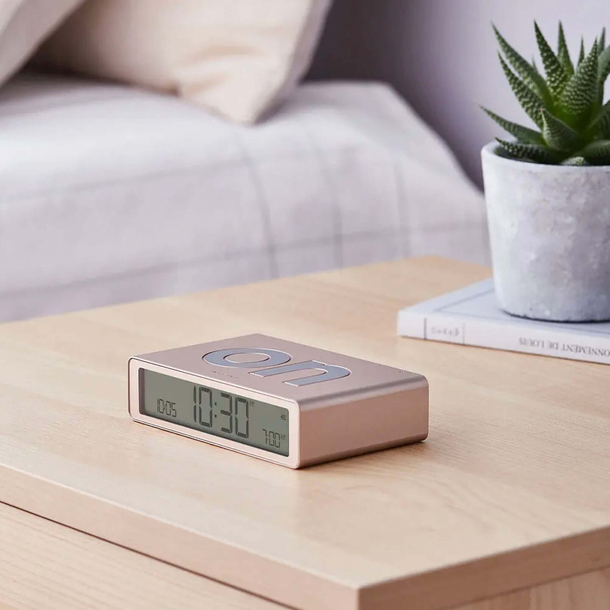 A reversible Lexon Flip Classic alarm clock with a soft gold finish, displaying the time 10:30 on its LCD screen.