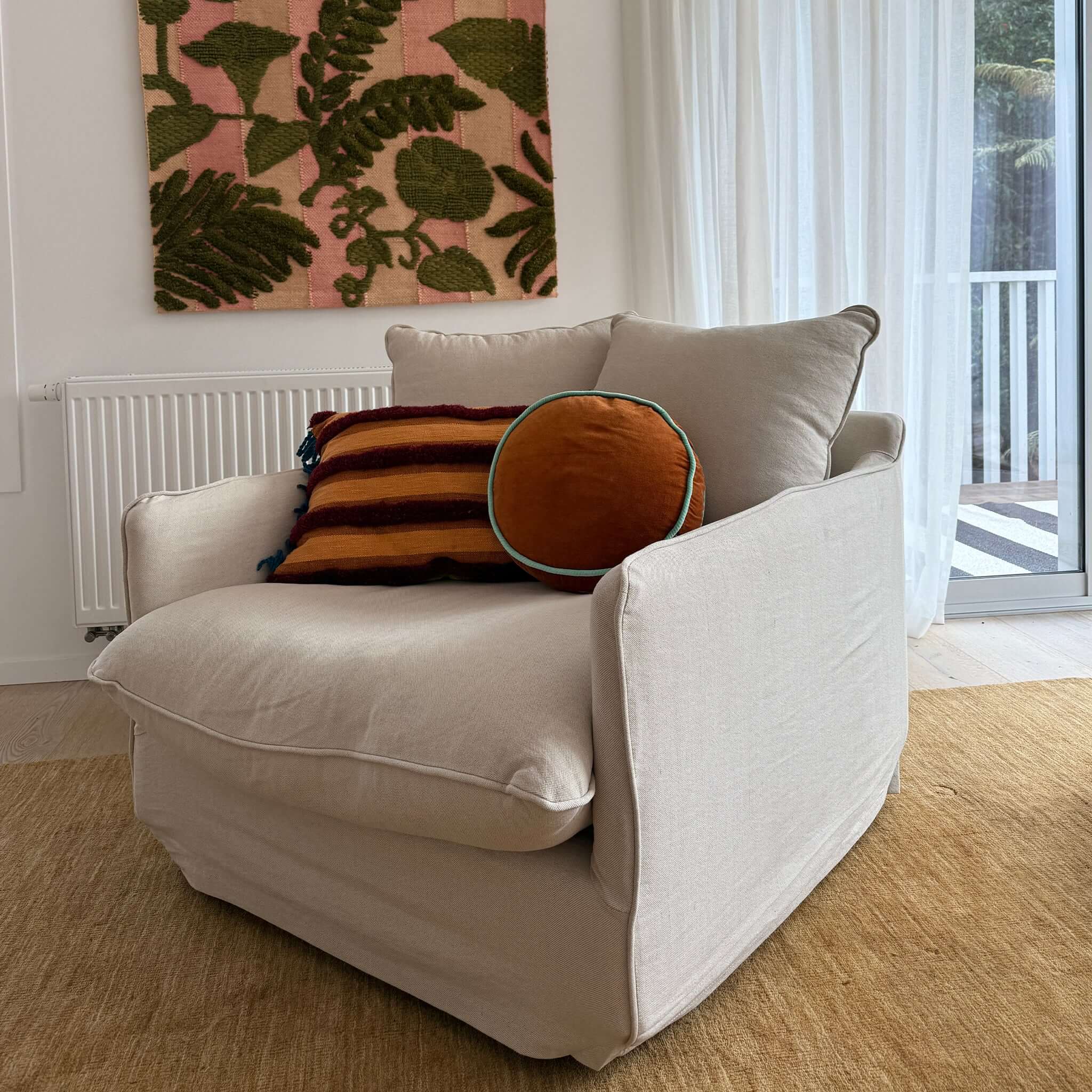 Alt Tag: Lotus Armchair with deep seat and feather-filled cushions, slipcovered in light fabric for timeless comfort in a modern living room