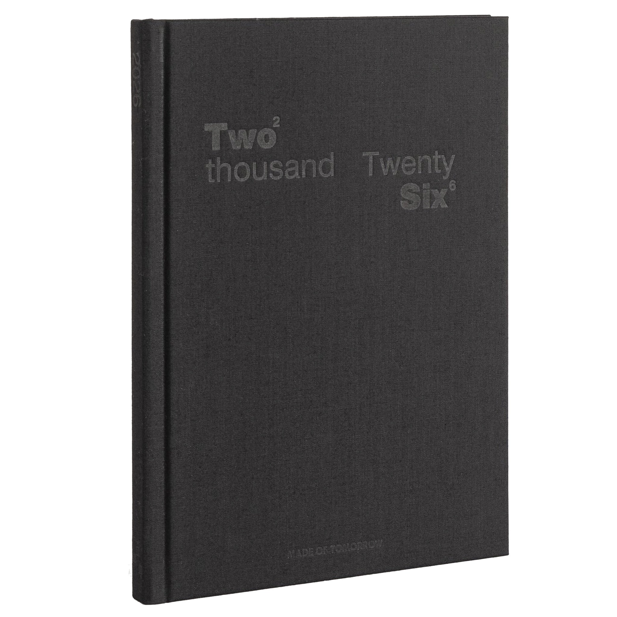 Black notebook with 'Two thousand Twenty Six' text on a white background