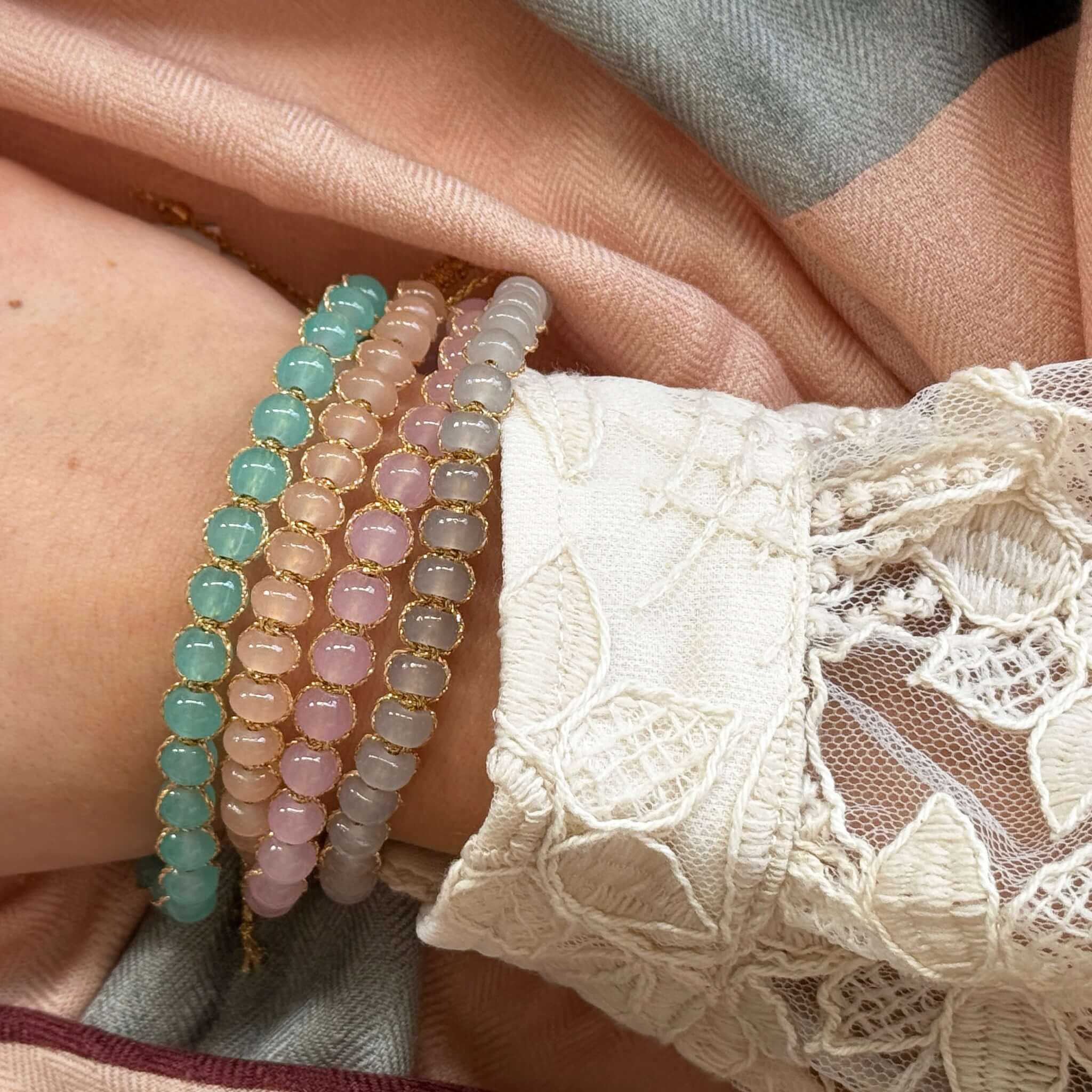 Margaret Edna Bracelet stacked with other colorful bracelets on a wrist, showcasing its unique design and adjustable fit.