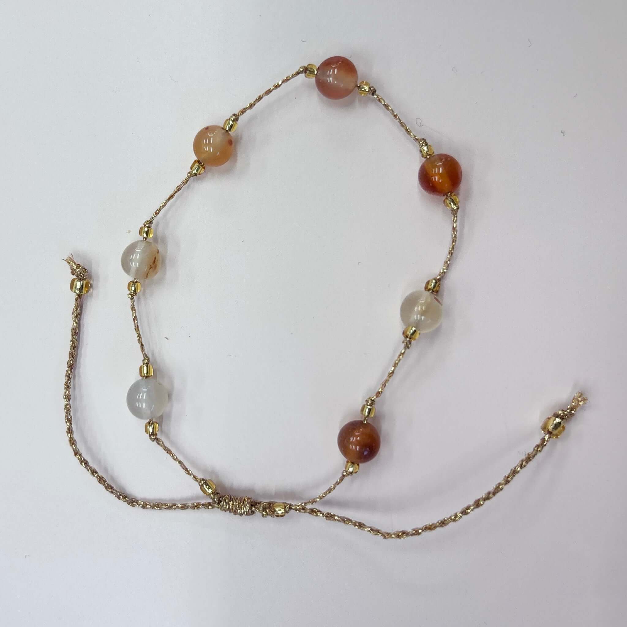 Margaret Loretta Bracelet featuring large round stone beads in warm honey carnelian and pale milky grey tones.