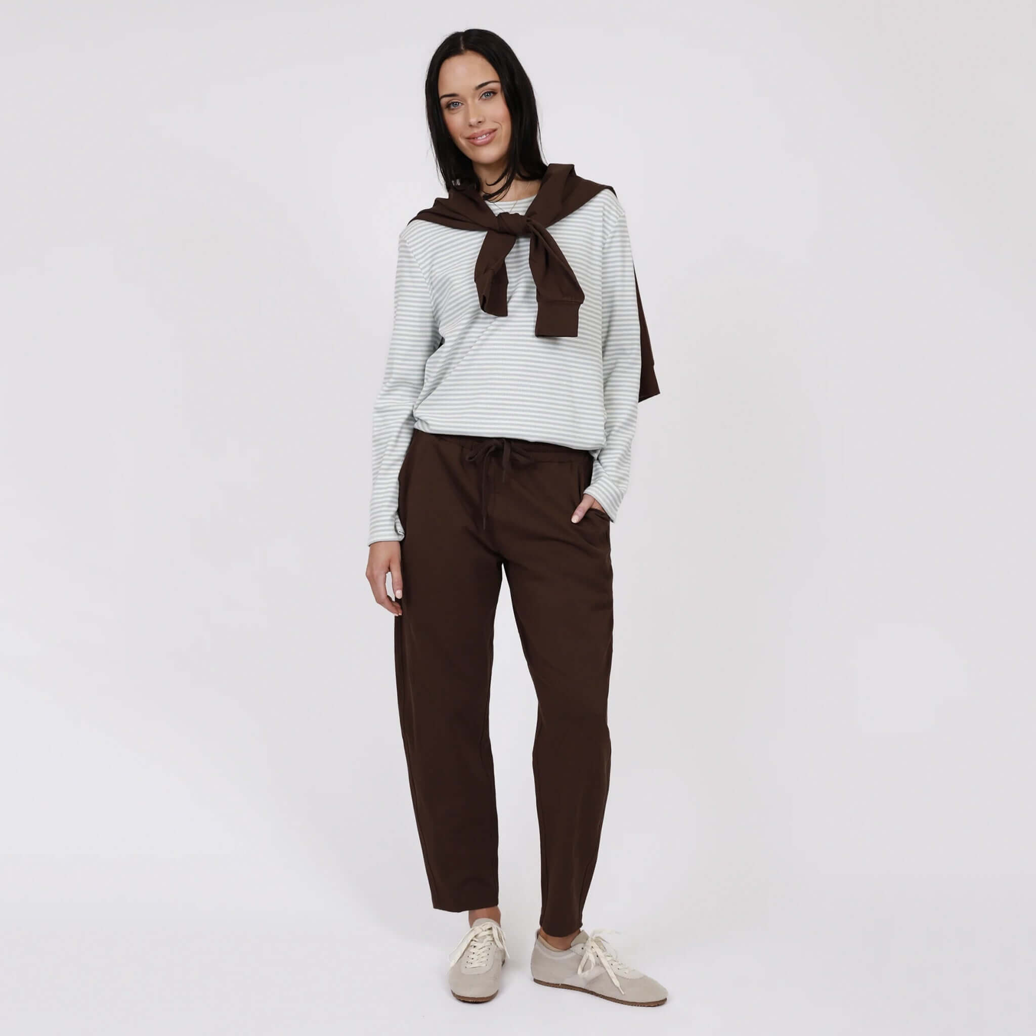 Model wearing Marlow Barrel Trackie - Java with a striped top and relaxed fit, showcasing comfort and style.