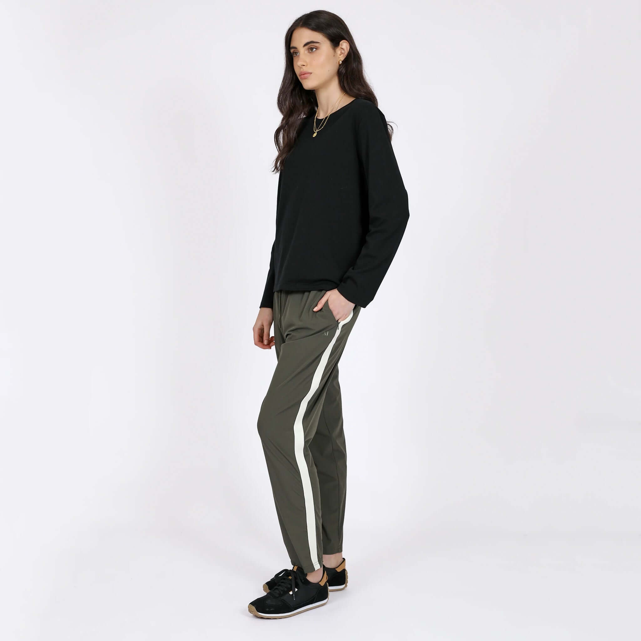 Marlow Transit Pants - Olive on model, featherlight stretch travel pants with side stripe, breathable quick-dry wrinkle-resistant fit