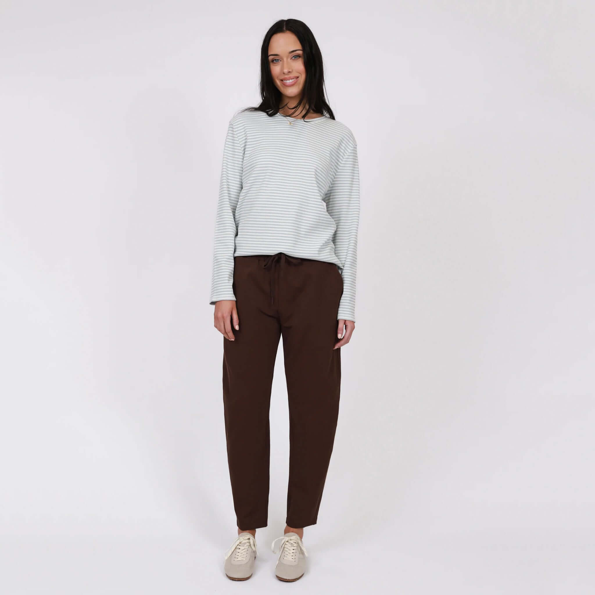 Model wearing Marlow Barrel Trackie - Java with a relaxed fit and stylish design.