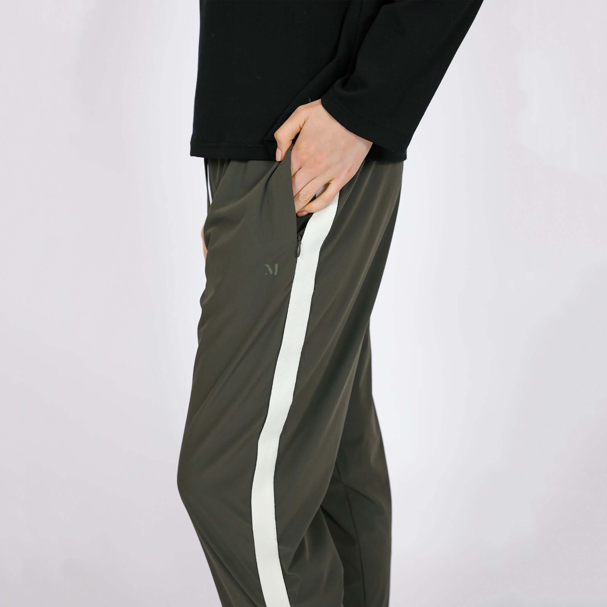 Alt Tag: Marlow Transit Pants - Olive side view with zip pocket, featherlight stretch travel pants in olive with white stripe