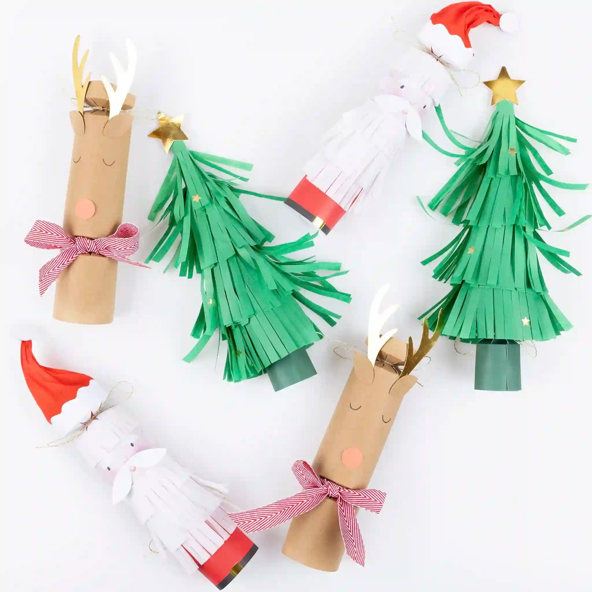 Handmade Christmas decorations including paper roll trees and reindeer on a white background