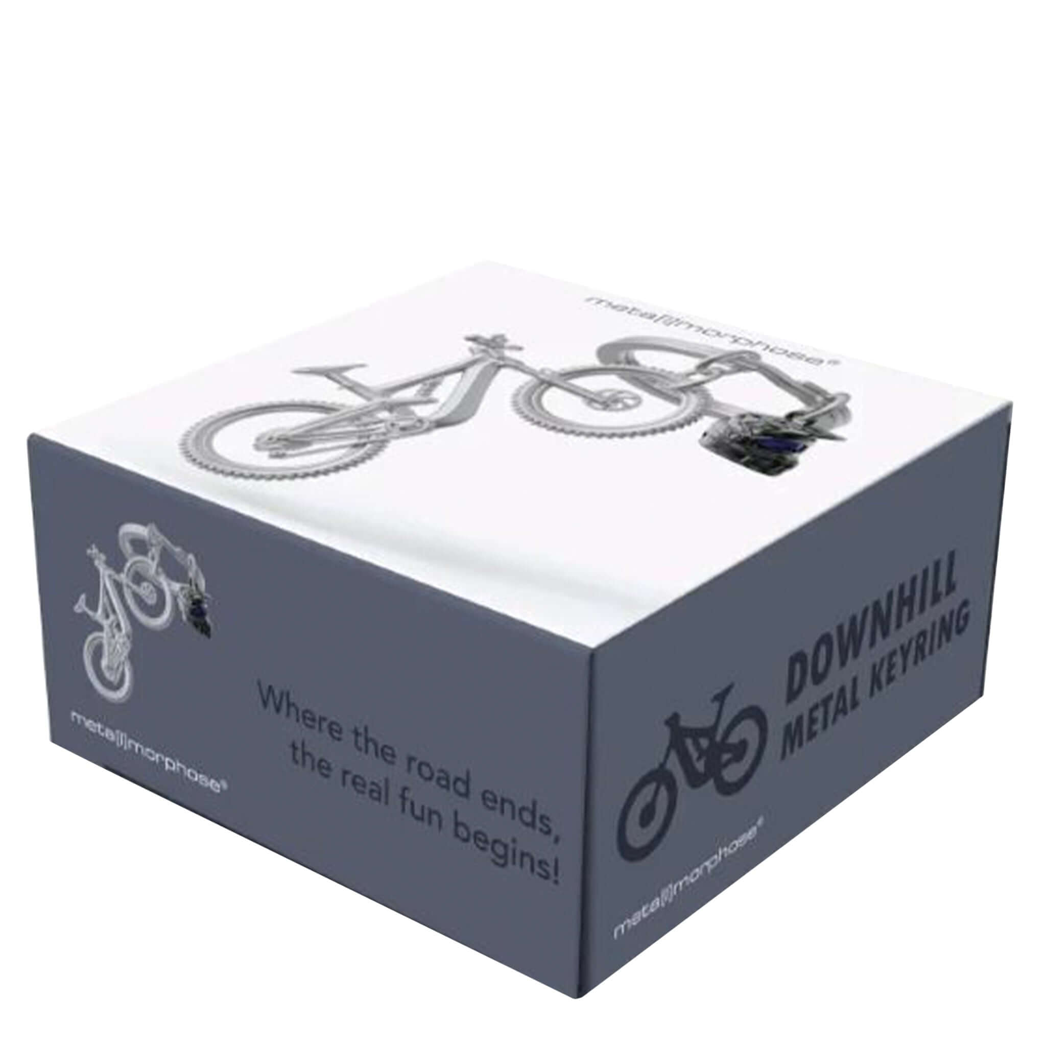 Box packaging for 'Downhill Metal Keyring' with bicycle graphics and text on a white background