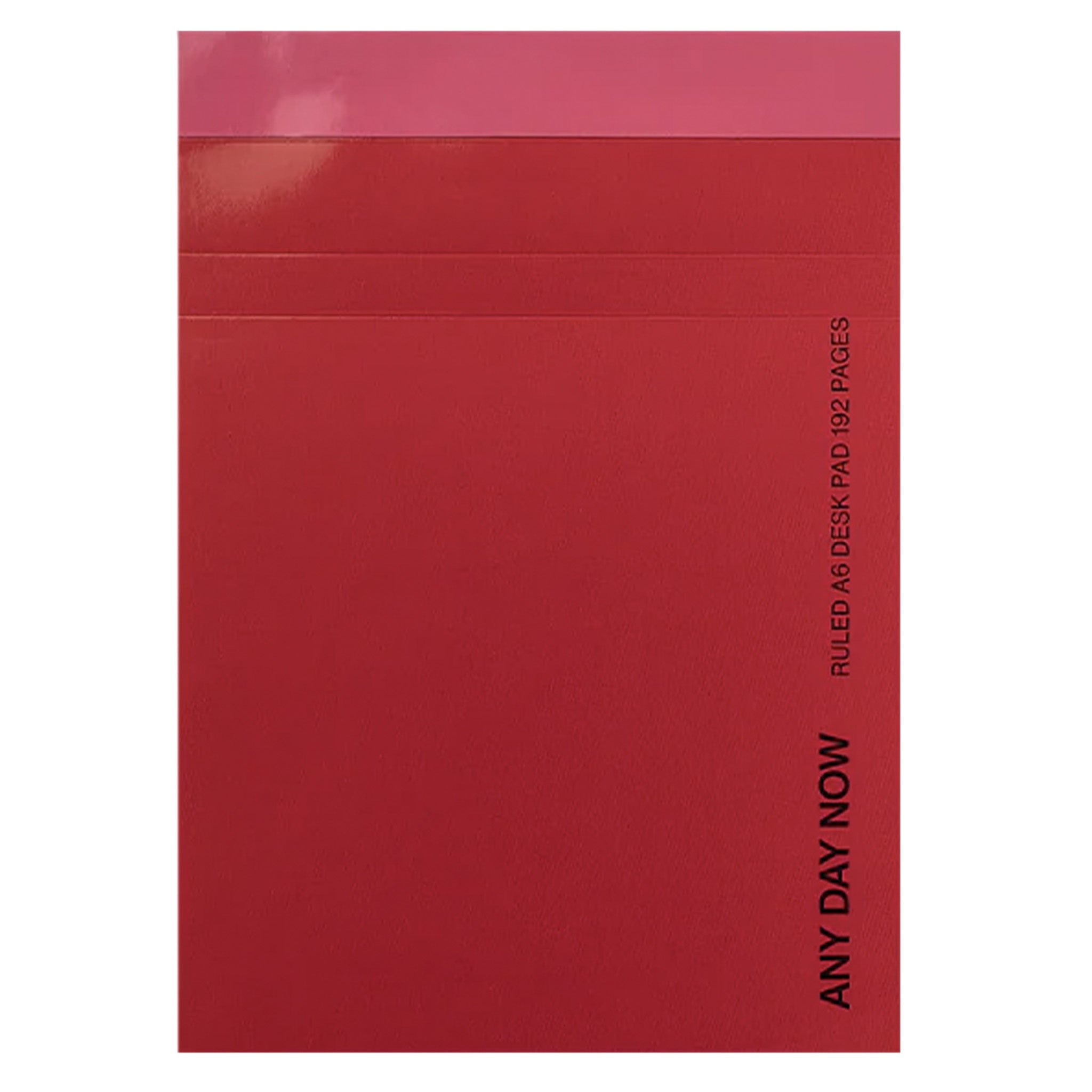 Red notebook with 'ANY DAY NOW' text on a white background