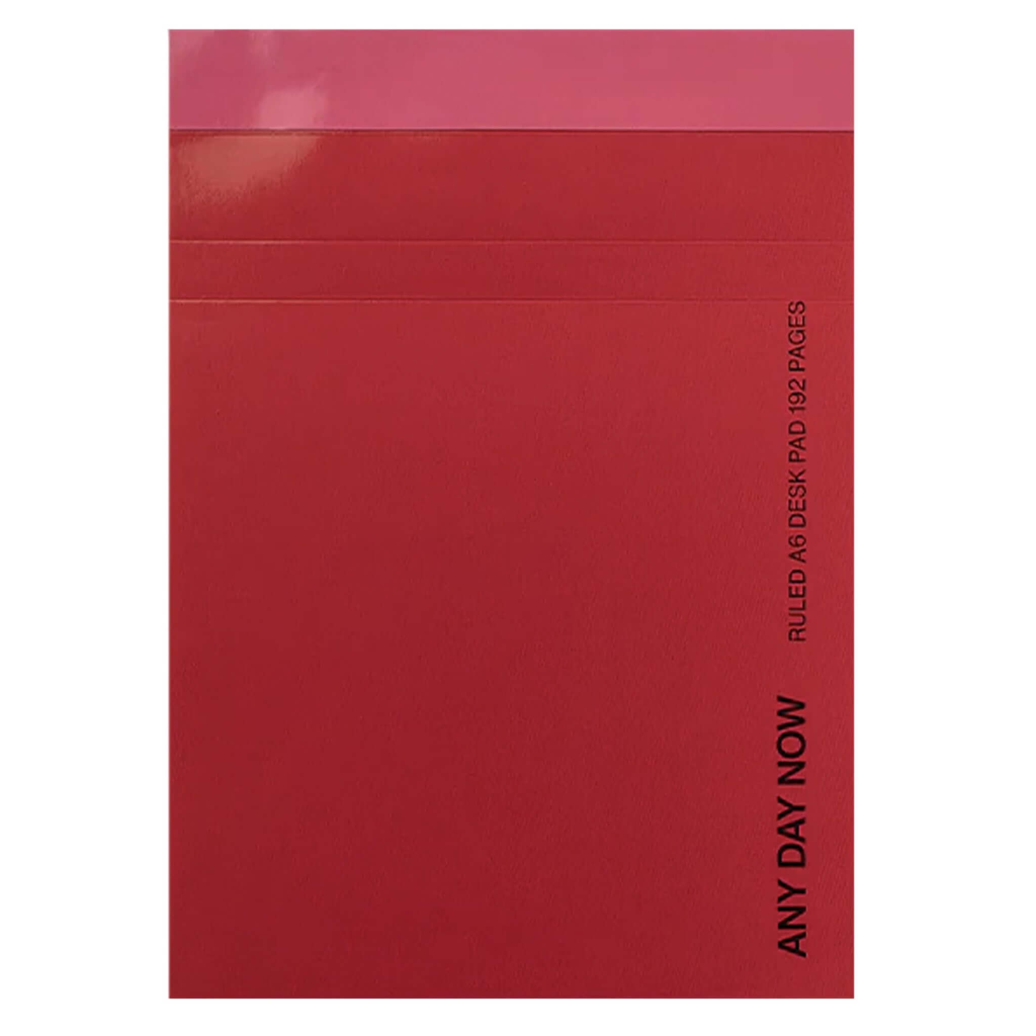 Red notebook with 'ANY DAY NOW' text on a white background