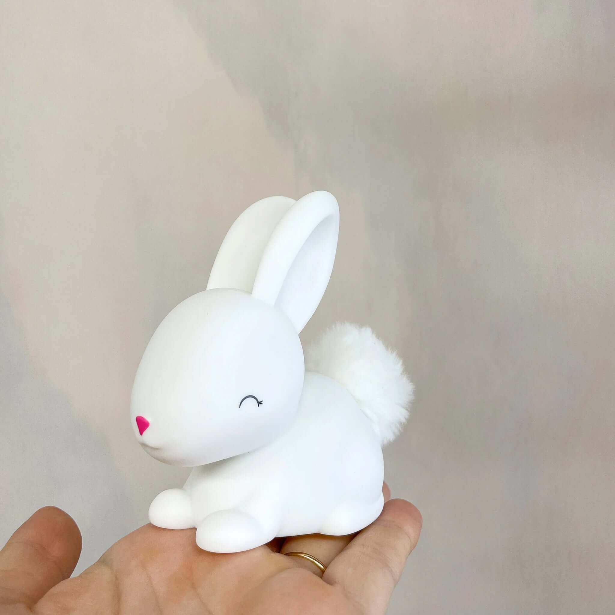 Mini Colour Changing LED Nightlight - Baby Bunny held in a hand for soft bedtime glow and comfort.