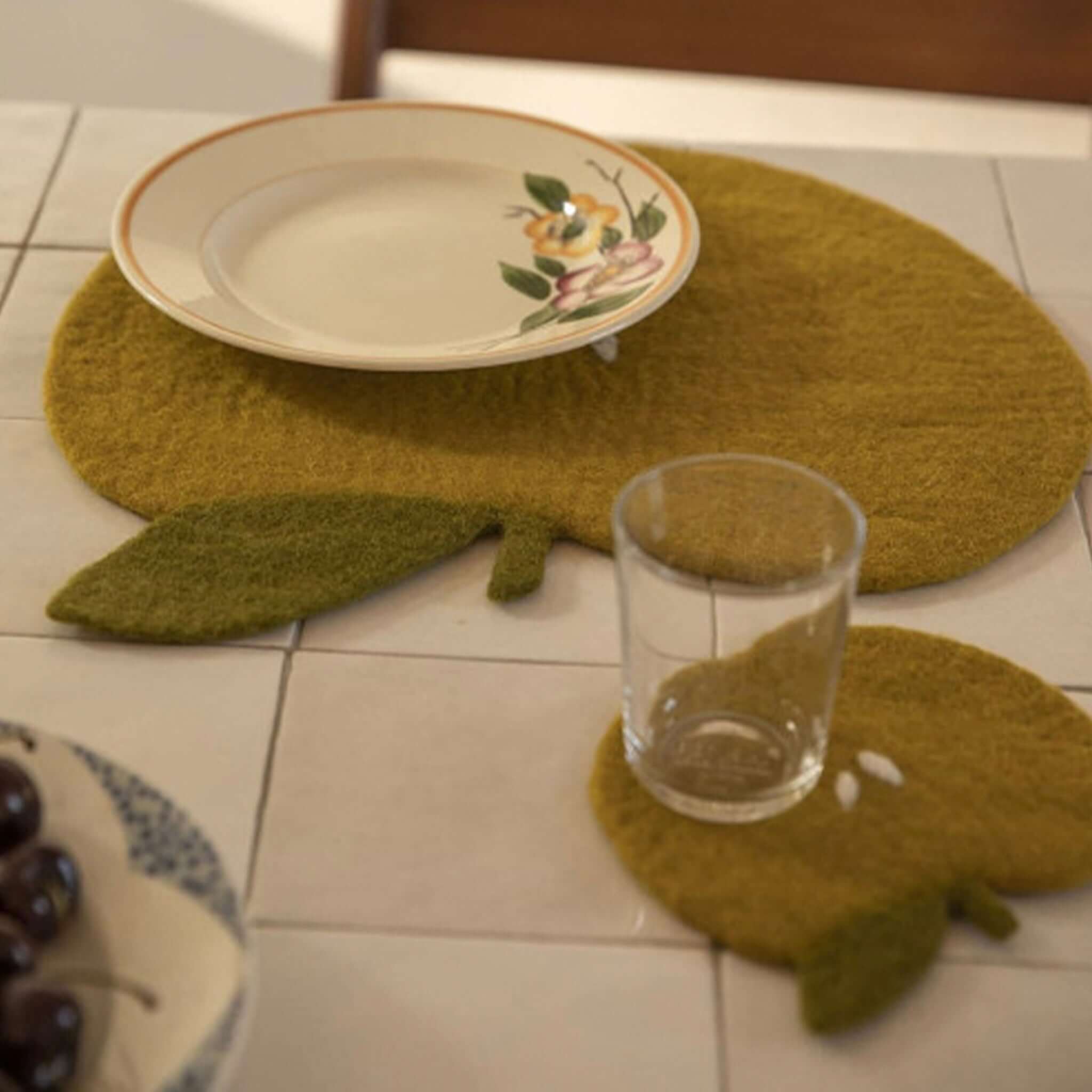 Muskhane Felt Apple Placemat - Pistachio wool felt apple placemat and coaster on table protecting surfaces from stains