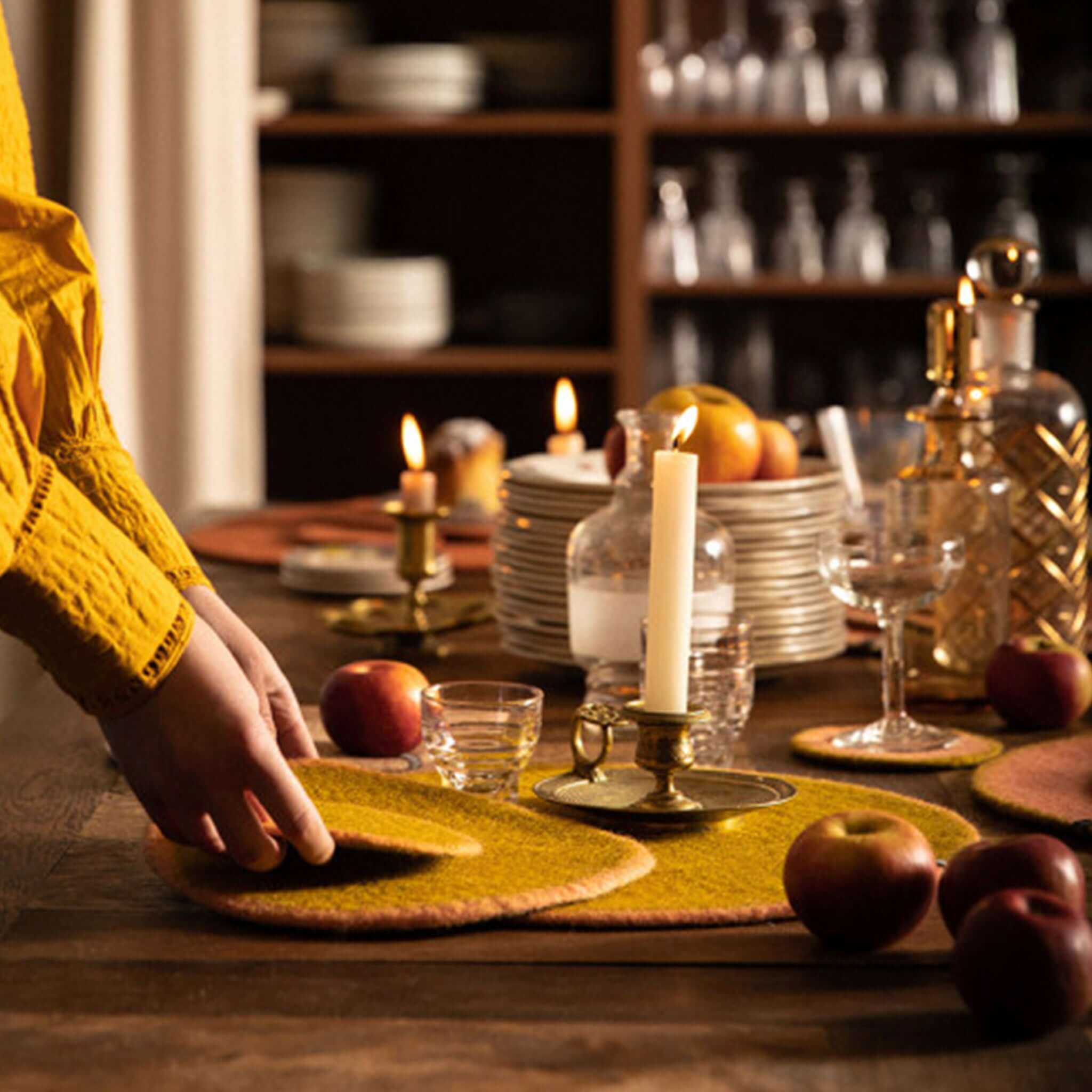 Muskhane Felt Two Tone Round Placemat - Nude & Pistachio Large on dining table as warm felt place setting and trivet