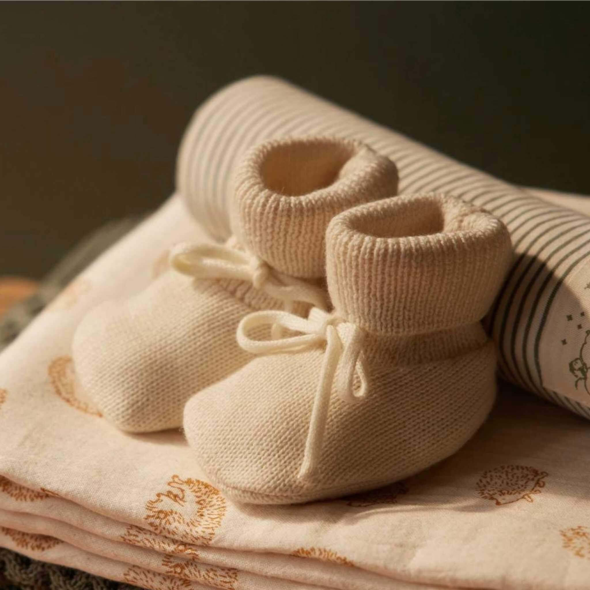 Alt Tag: Nature Baby Organic Merino Knit Drawstring Booties - Natural organic merino wool baby booties with fold-down cuff and ankle drawstring