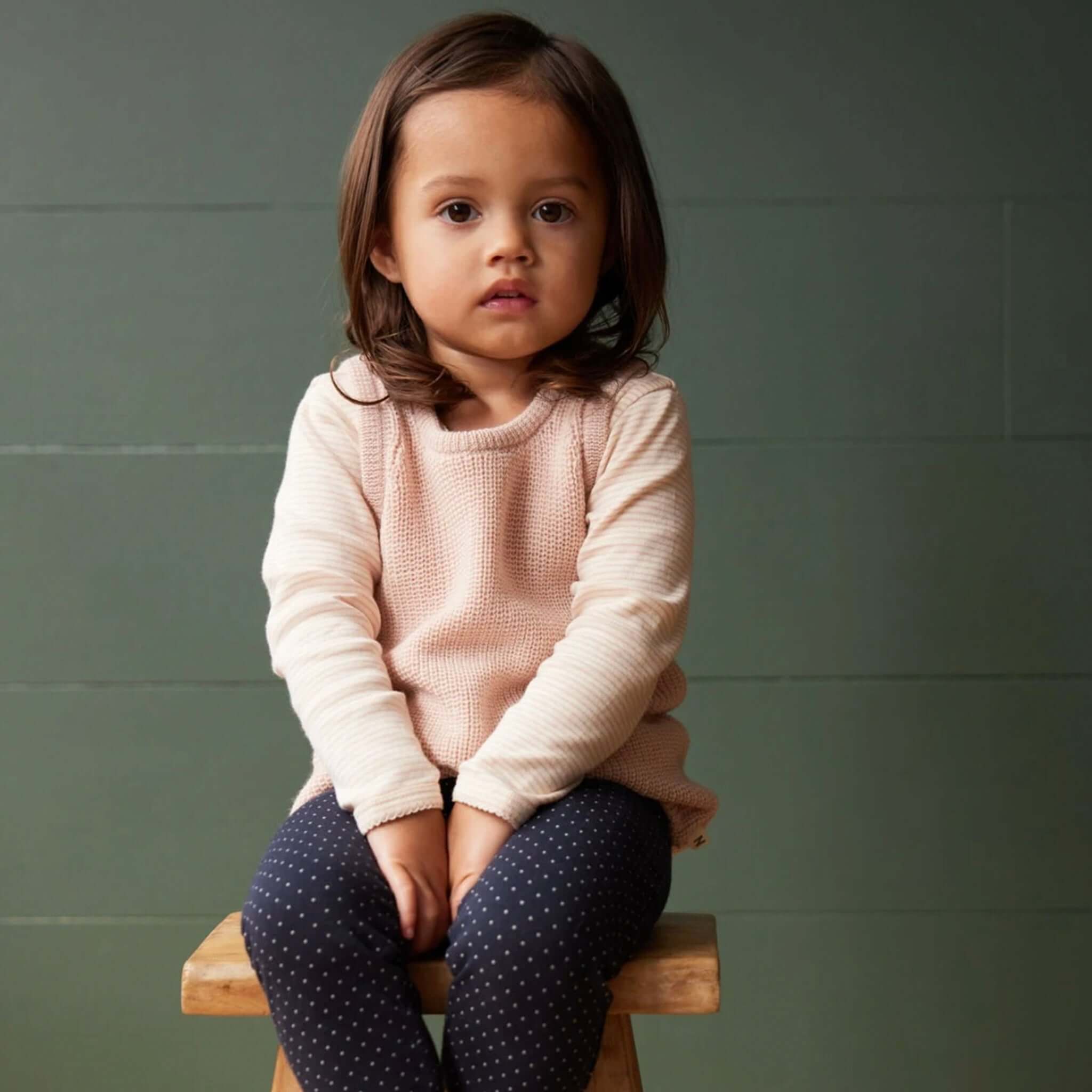 Alt Tag: Nature Baby Organic Merino Knit Vest - Rose Dust on child, organic merino wool chunky knit layering vest with ribbed trims