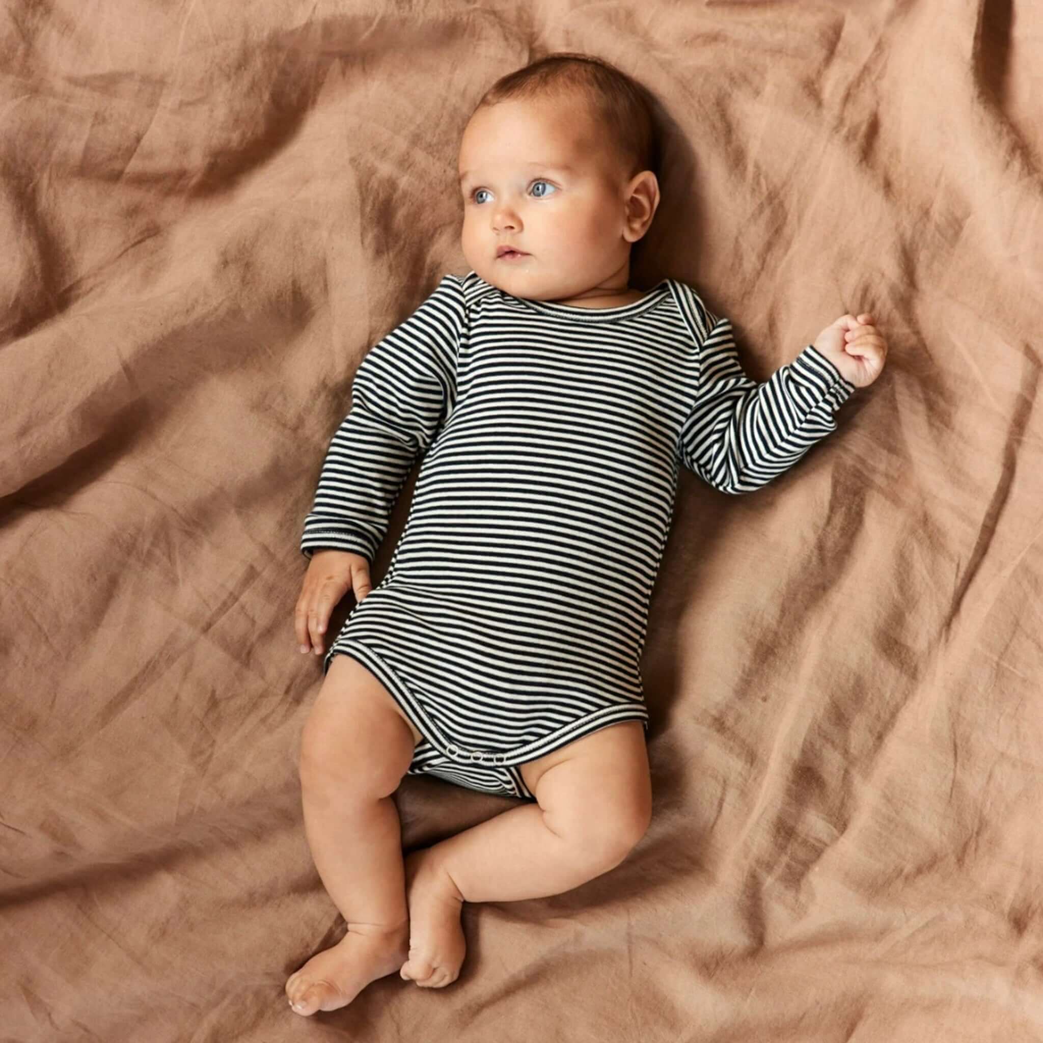 Alt Tag: Nature Baby Organic Cotton Long Sleeve Bodysuit - Navy Stripe on baby, GOTS-certified 100% organic cotton long sleeve striped bodysuit