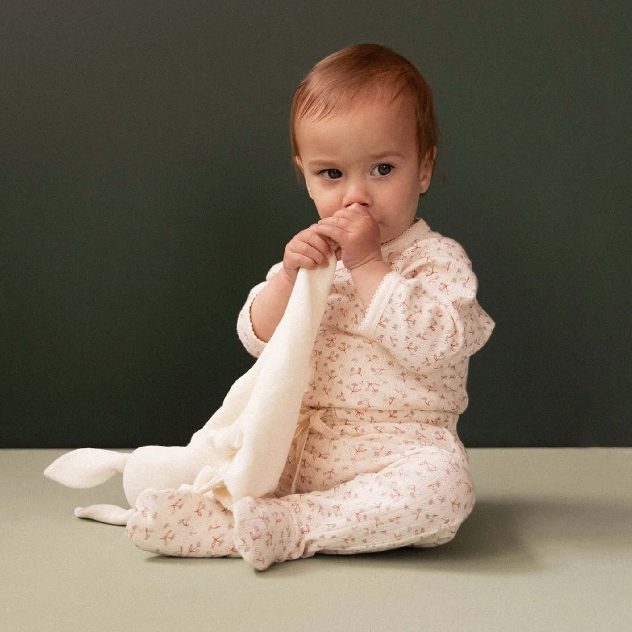 Nature Baby Organic Cotton Pointelle Footed Romper - Dandelion, a cozy baby romper with enclosed feet for warmth.