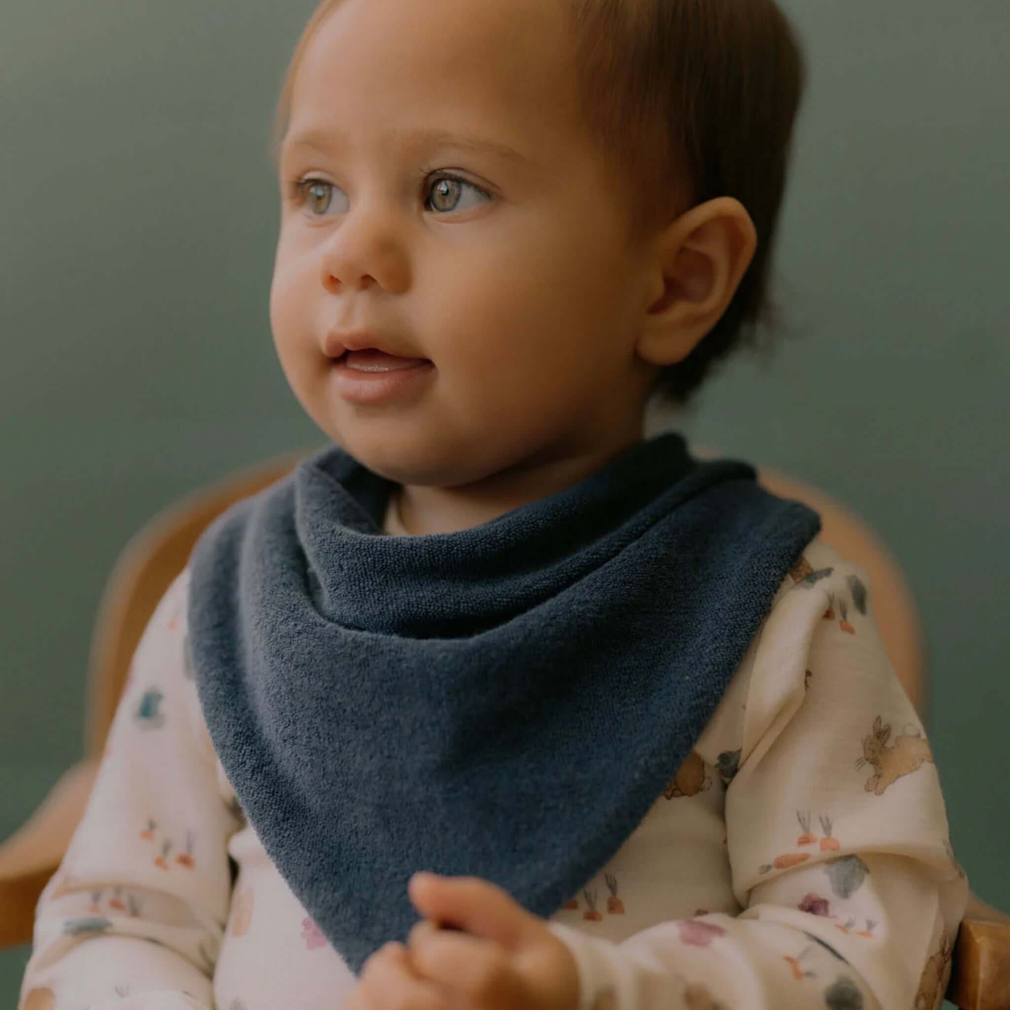 Alt Tag: Nature Baby Organic Cotton Terry Triangle Bib - Dusky Blue on baby, soft organic cotton terry bib for teething dribbles