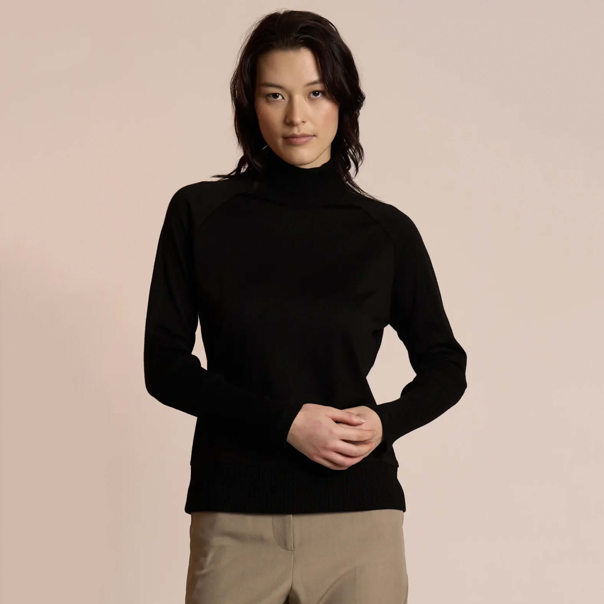 Neris Side Story Merino Jumper - Black on model, lightweight 100% merino wool knit with funnel neck, relaxed fit for layering
