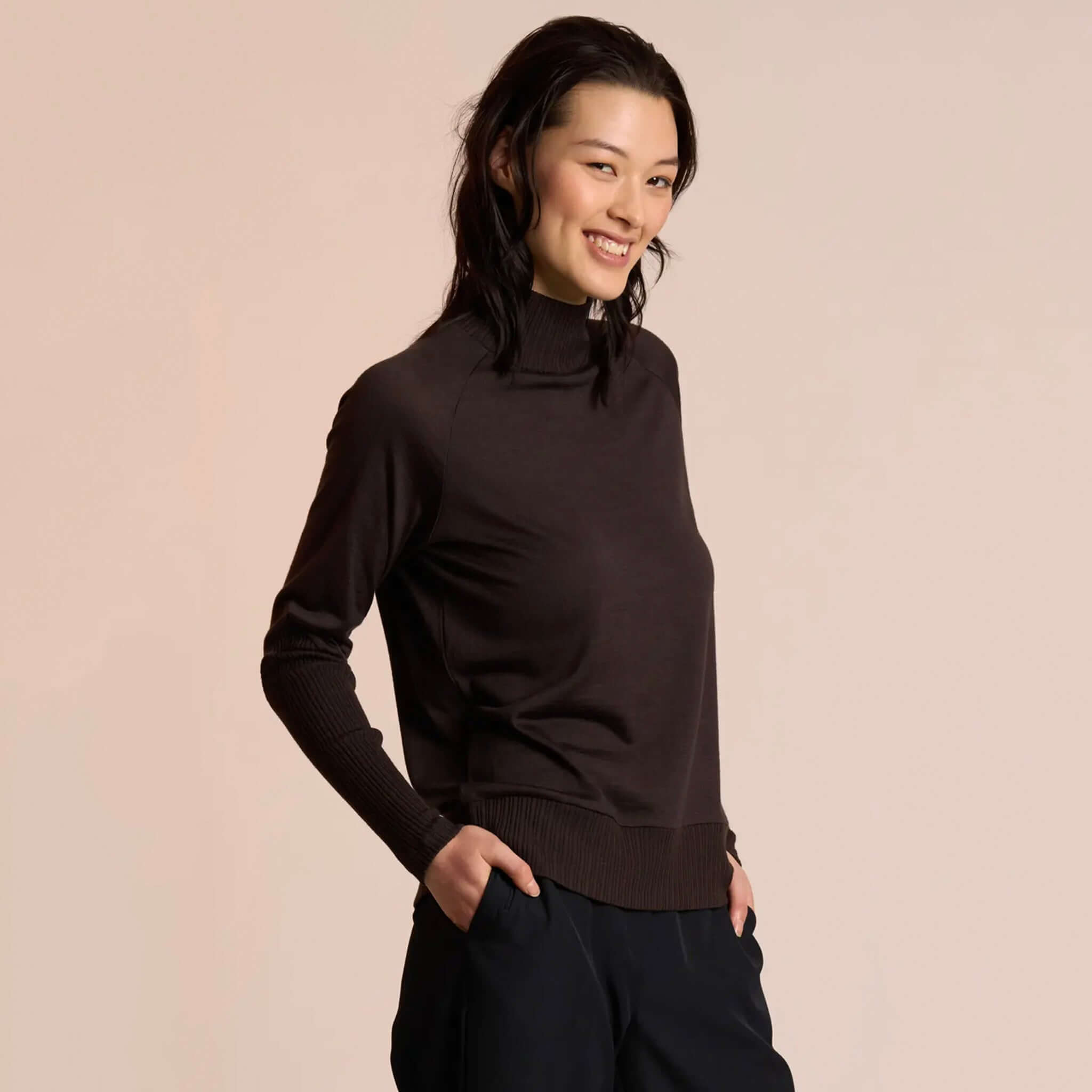 Neris Side Story Merino Jumper - Bitter Sweet on model, soft 100% merino wool knit with relaxed fit and funnel neck