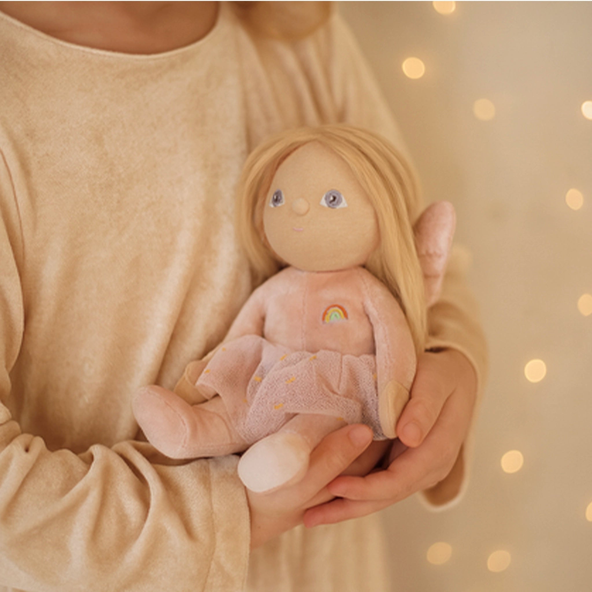 Person holding a soft toy with a blurred background
