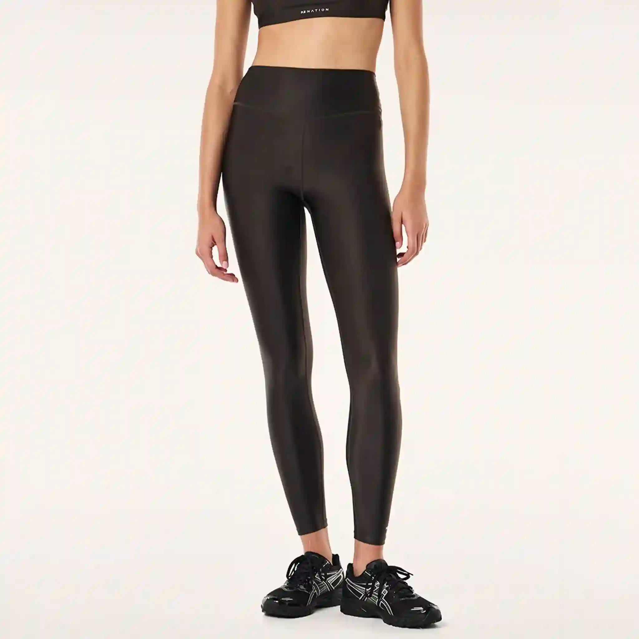 Person wearing black leggings on a white background