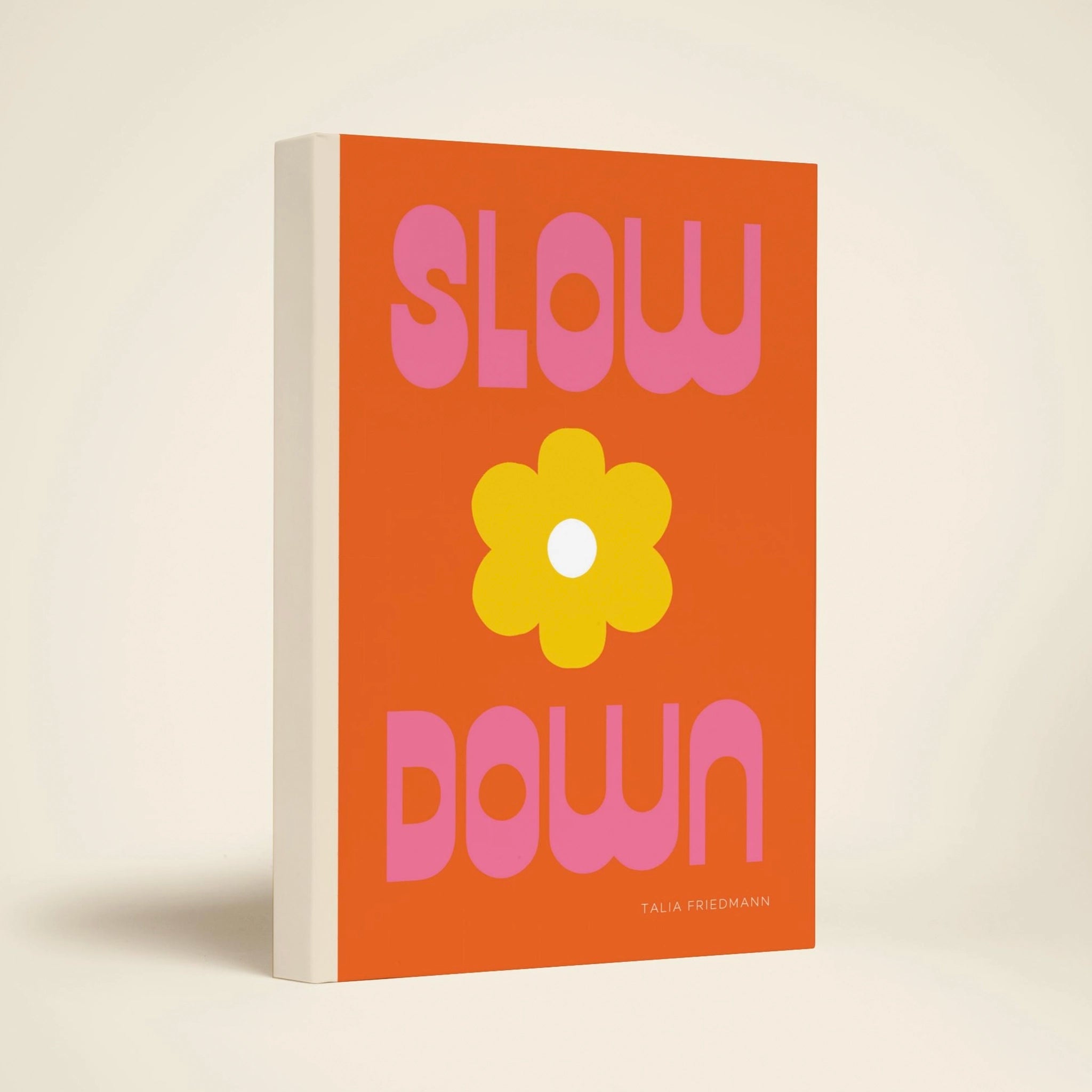 Book cover with 'Slow Down' text and a flower on an orange background