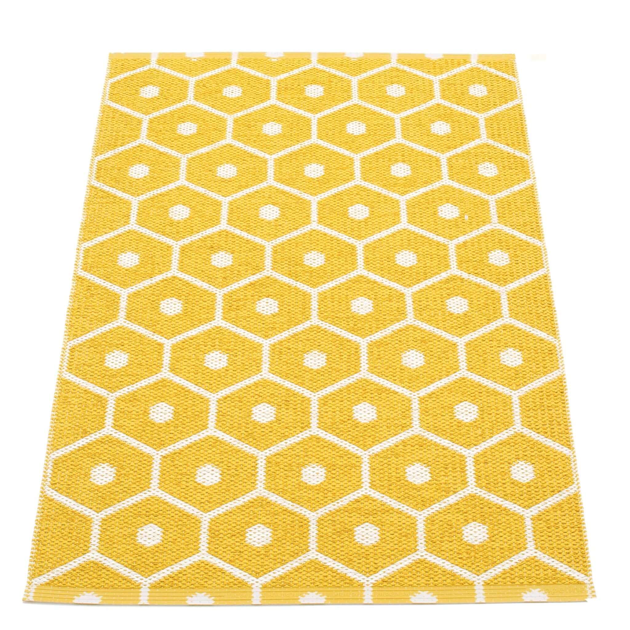 Pappelina Sweden Honey Reversible Mat - Mustard & Vanilla featuring a honeycomb pattern in yellow and white.
