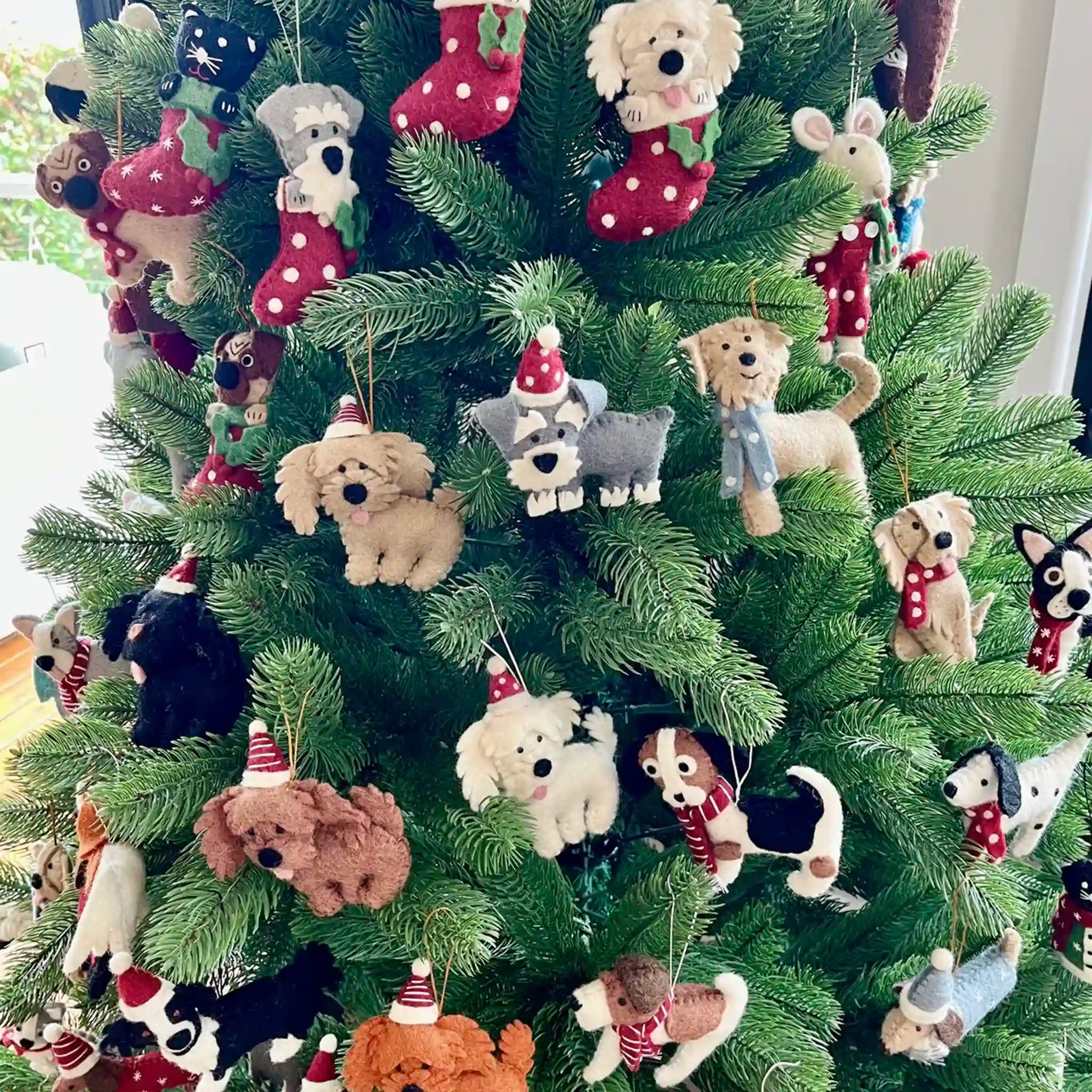 Christmas tree decorated with various dog-themed ornaments.
