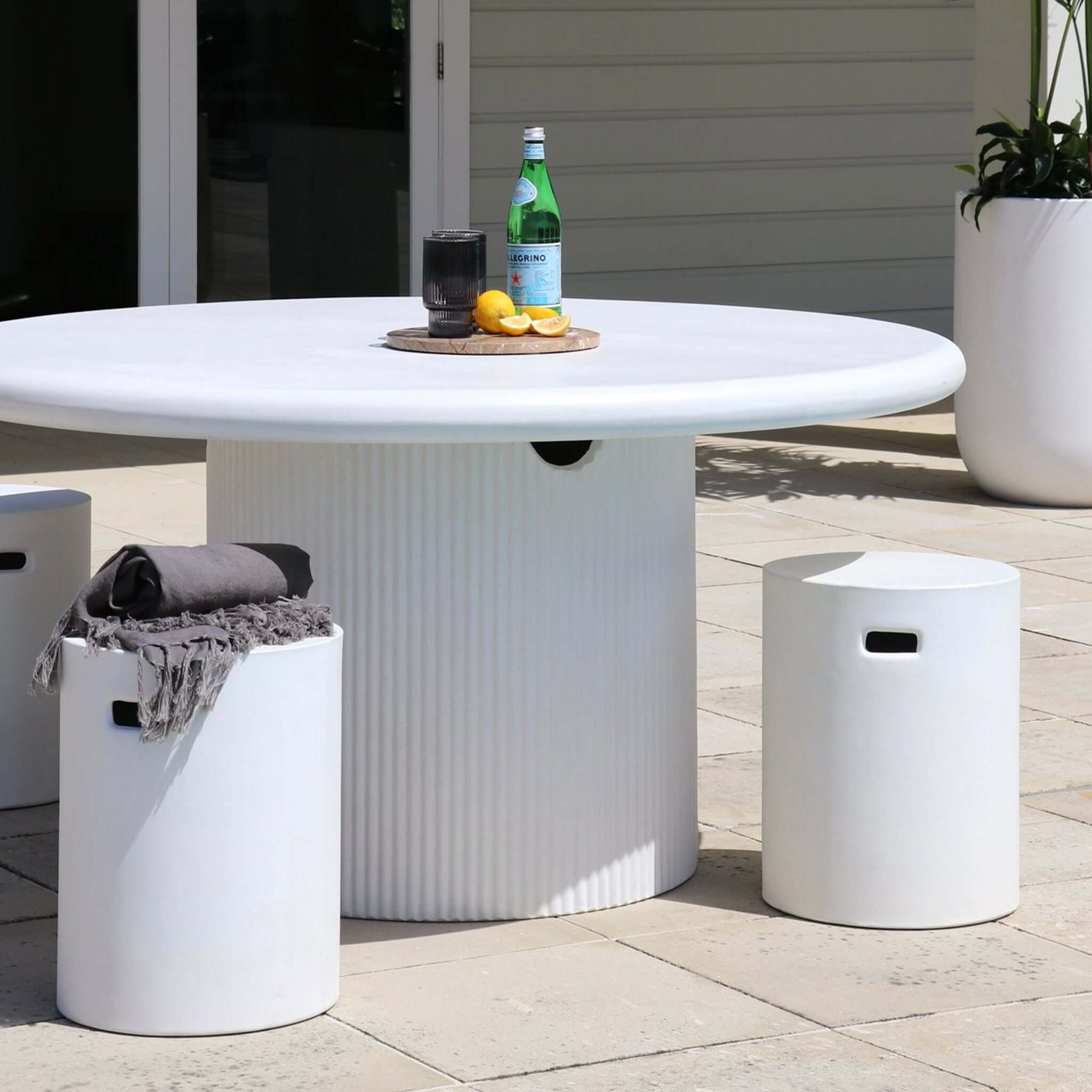 Concrete Side Table / Stool - Round minimalist concrete stool used as outdoor side table on patio next to round table
