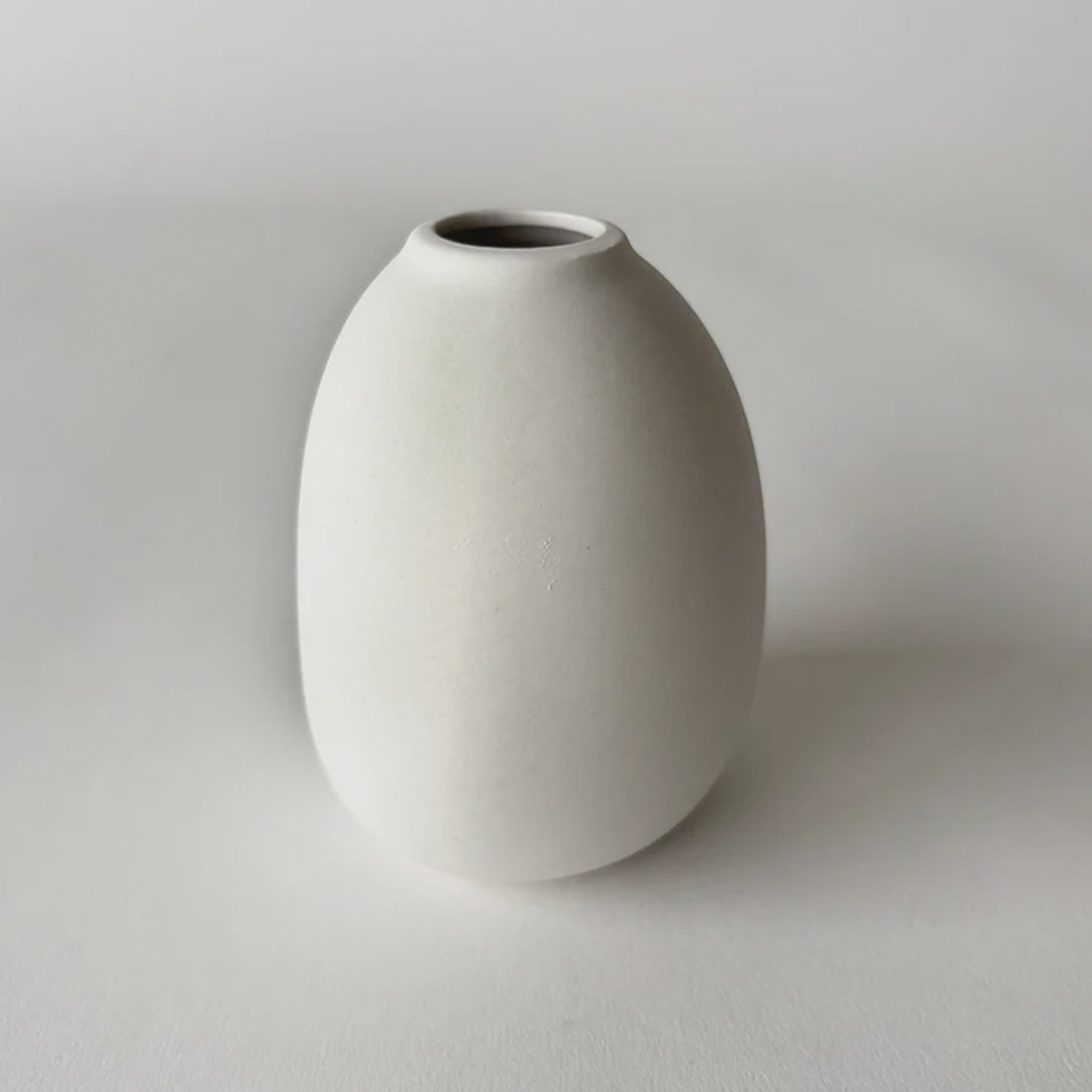 White ceramic vase on a plain background