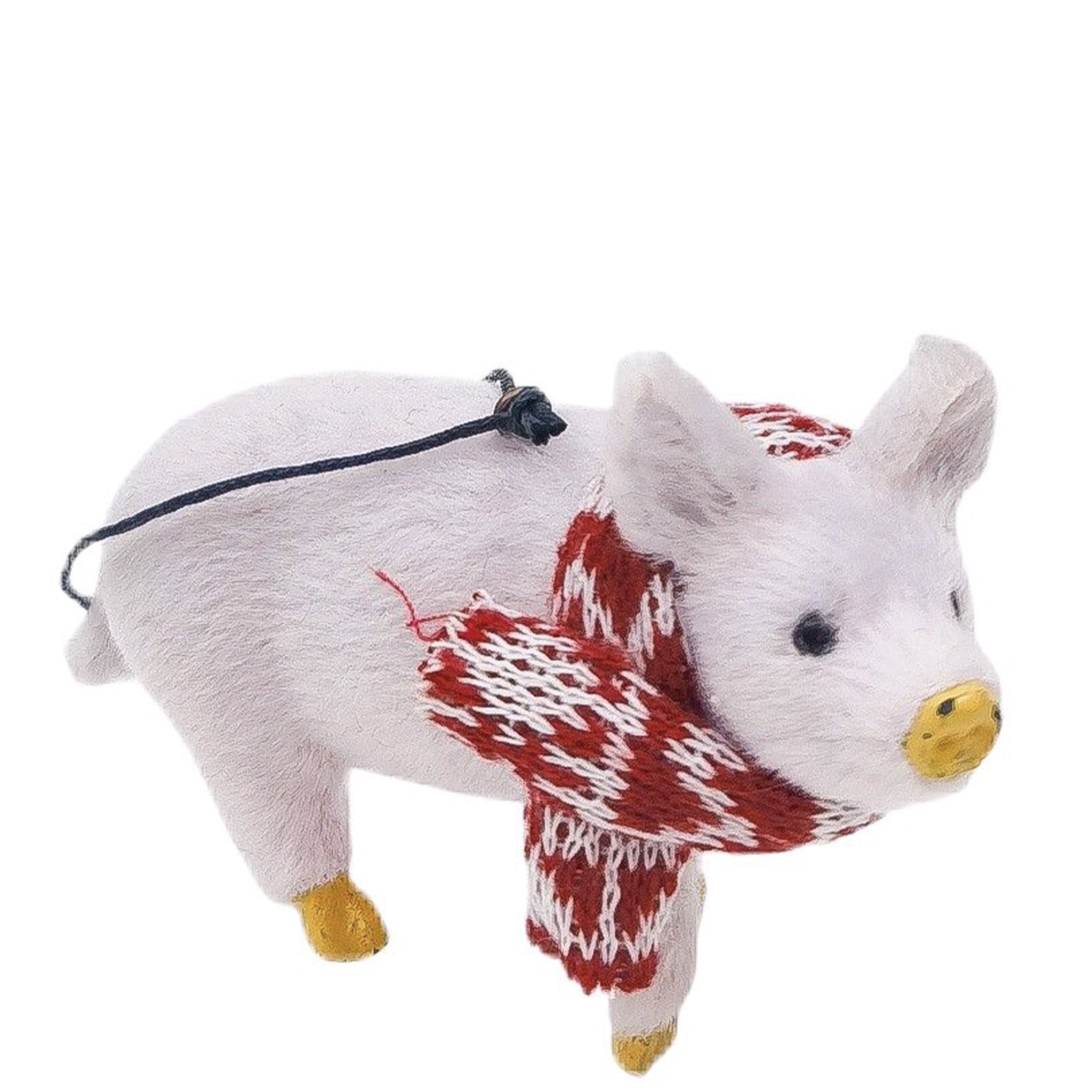 Plush toy pig with a red and white pattern on a white background