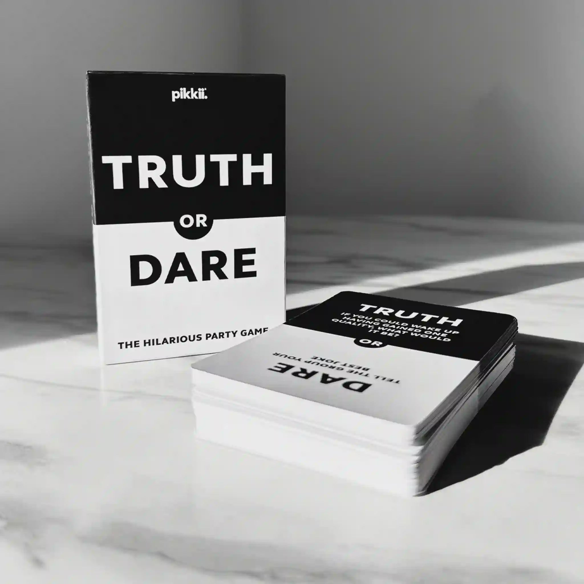 Truth or Dare game cards on a marble surface with a neutral background