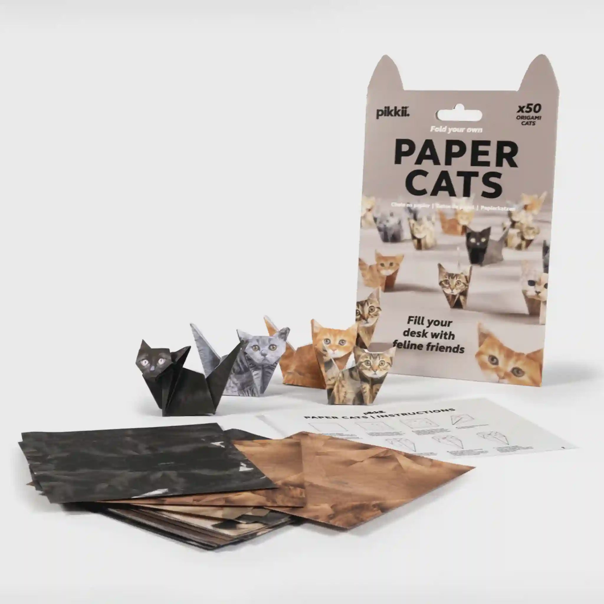 Packaging of paper cats with cut-out cats on a white background