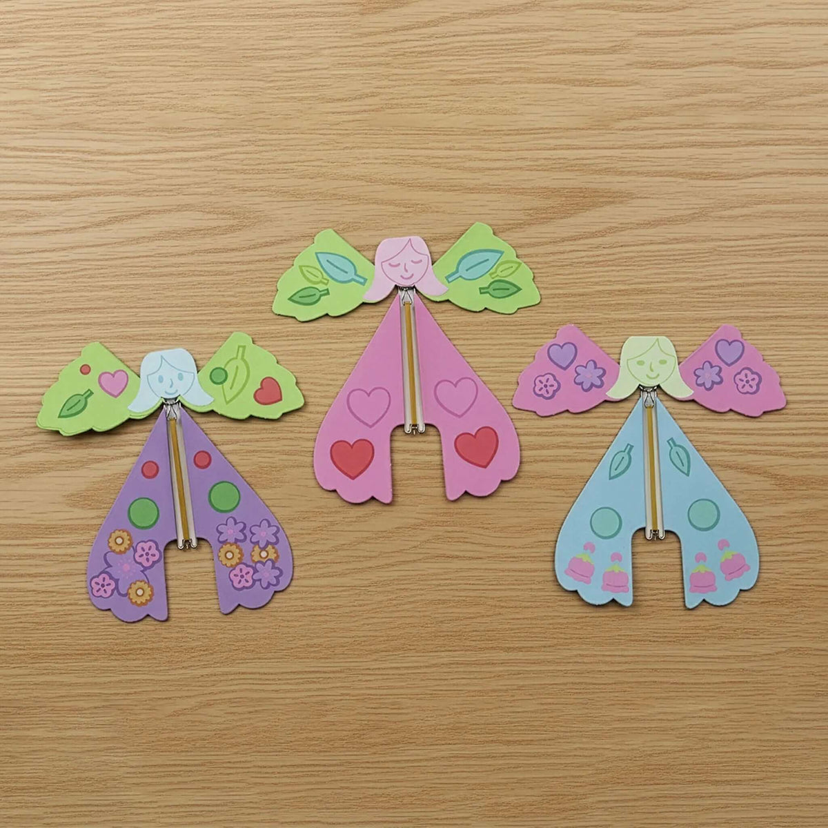 Pikkii Origami Paper Flying Fairies colorful handmade fairies with decorative wings on a wooden background.