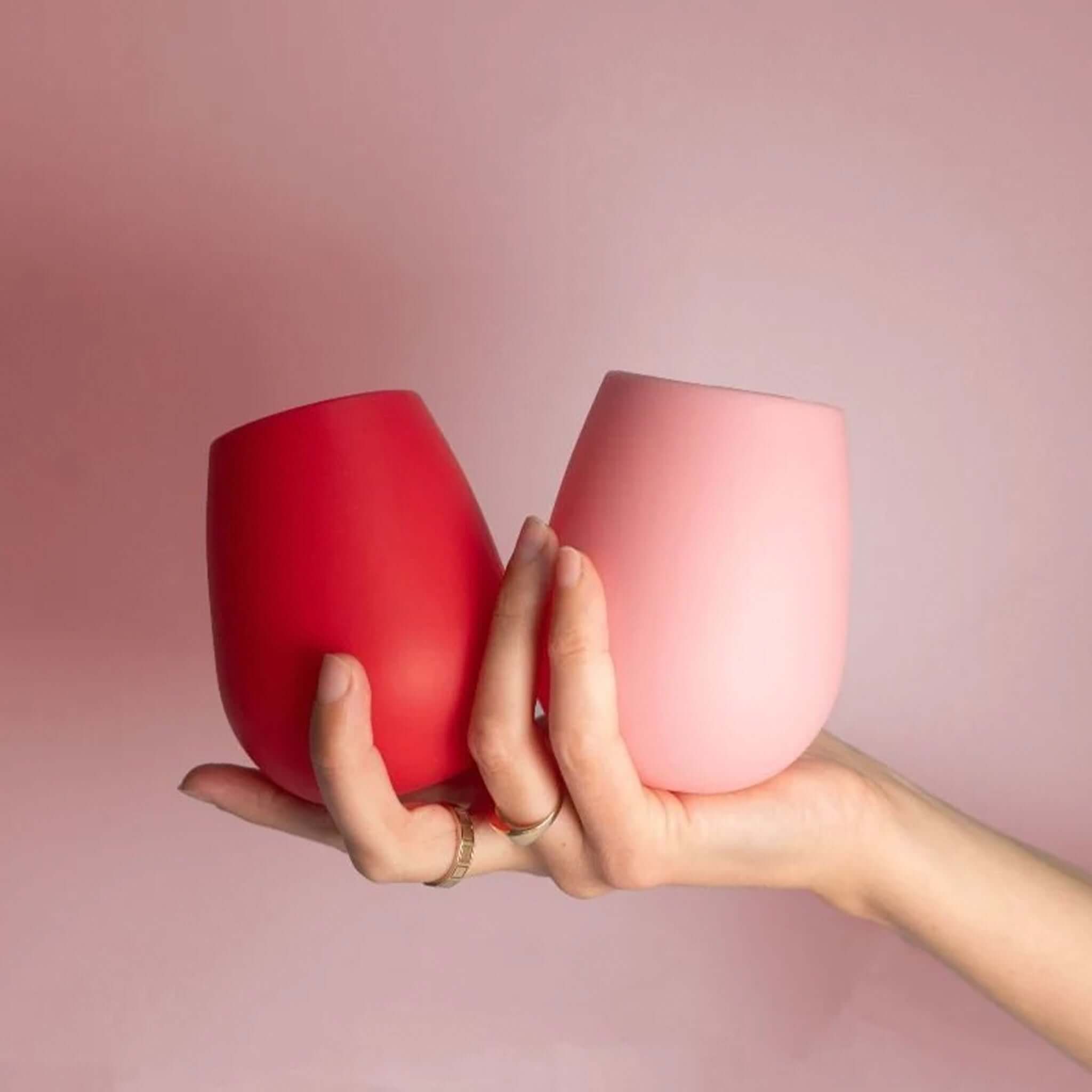 Porter Green Fegg Unbreakable Glass Set - Cherry & Blush in hand, showcasing red and pink silicone tumblers.