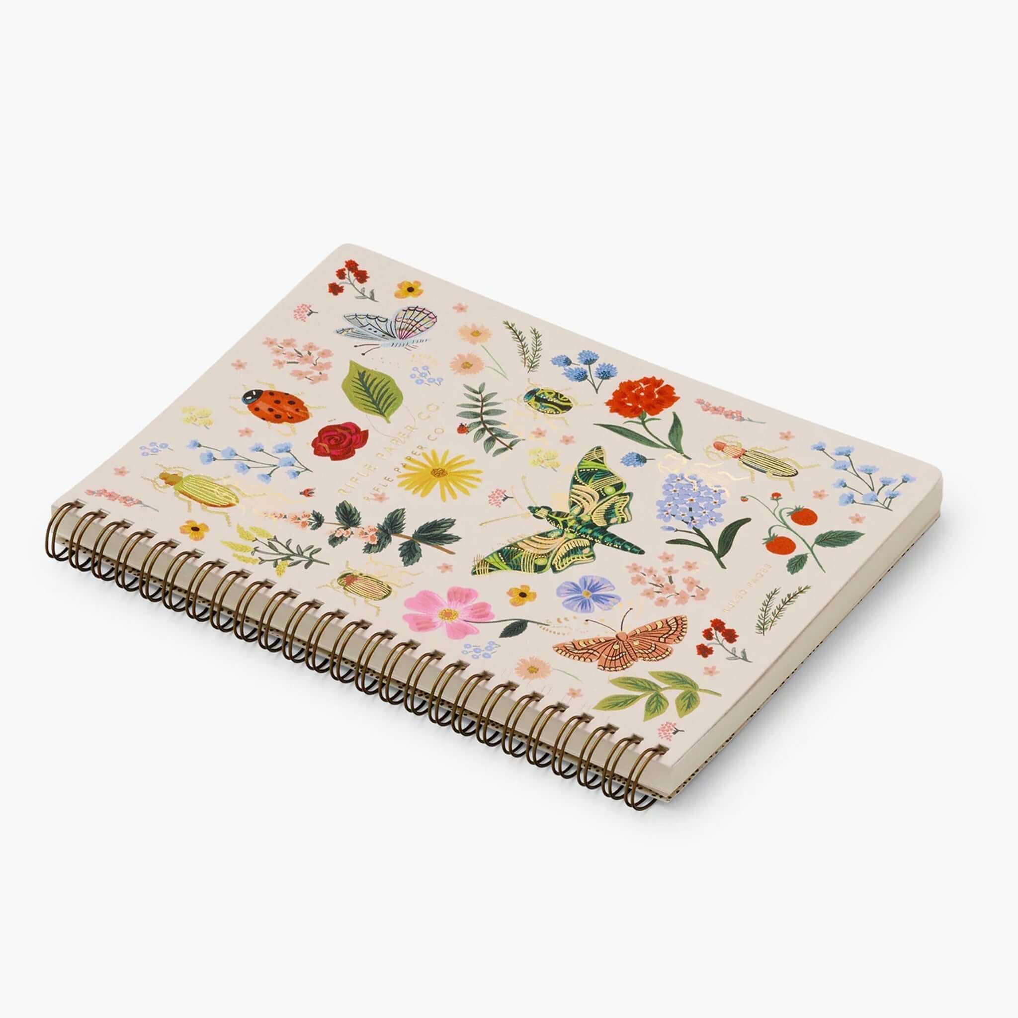 Rifle Paper US Spiral Notebook - Curio with botanical print and gold foil accents on a blush background.