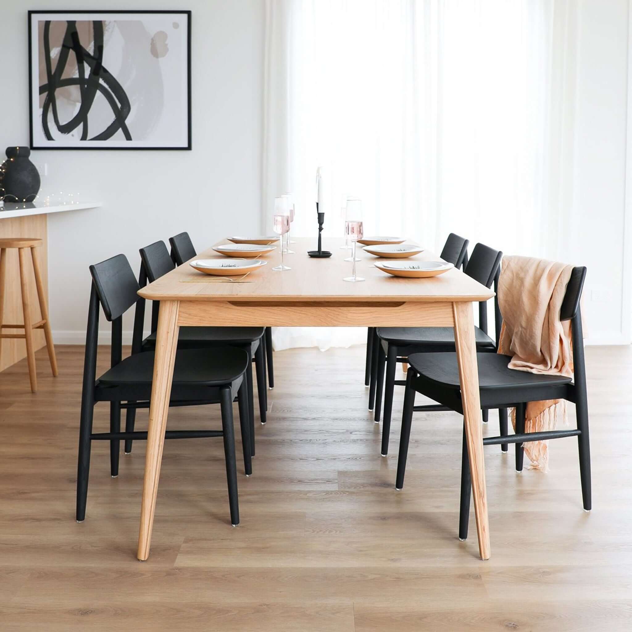 Alt Tag: Rokke Solid Oak Dining Table in Scandinavian dining room, light oak table set for six with black chairs and minimalist decor