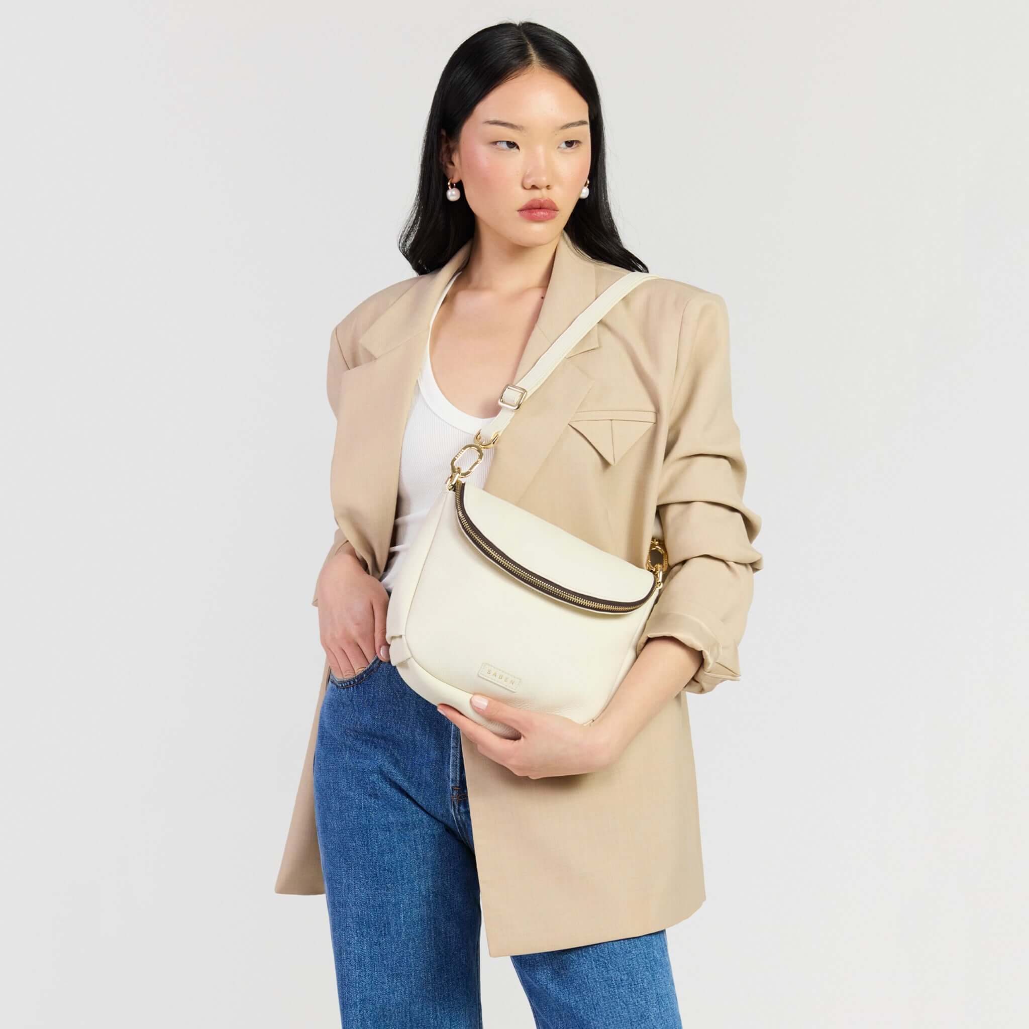 Saben Fifi Crossbody Bag - Quartz worn by a model in stylish attire, showcasing its compact and chic design.