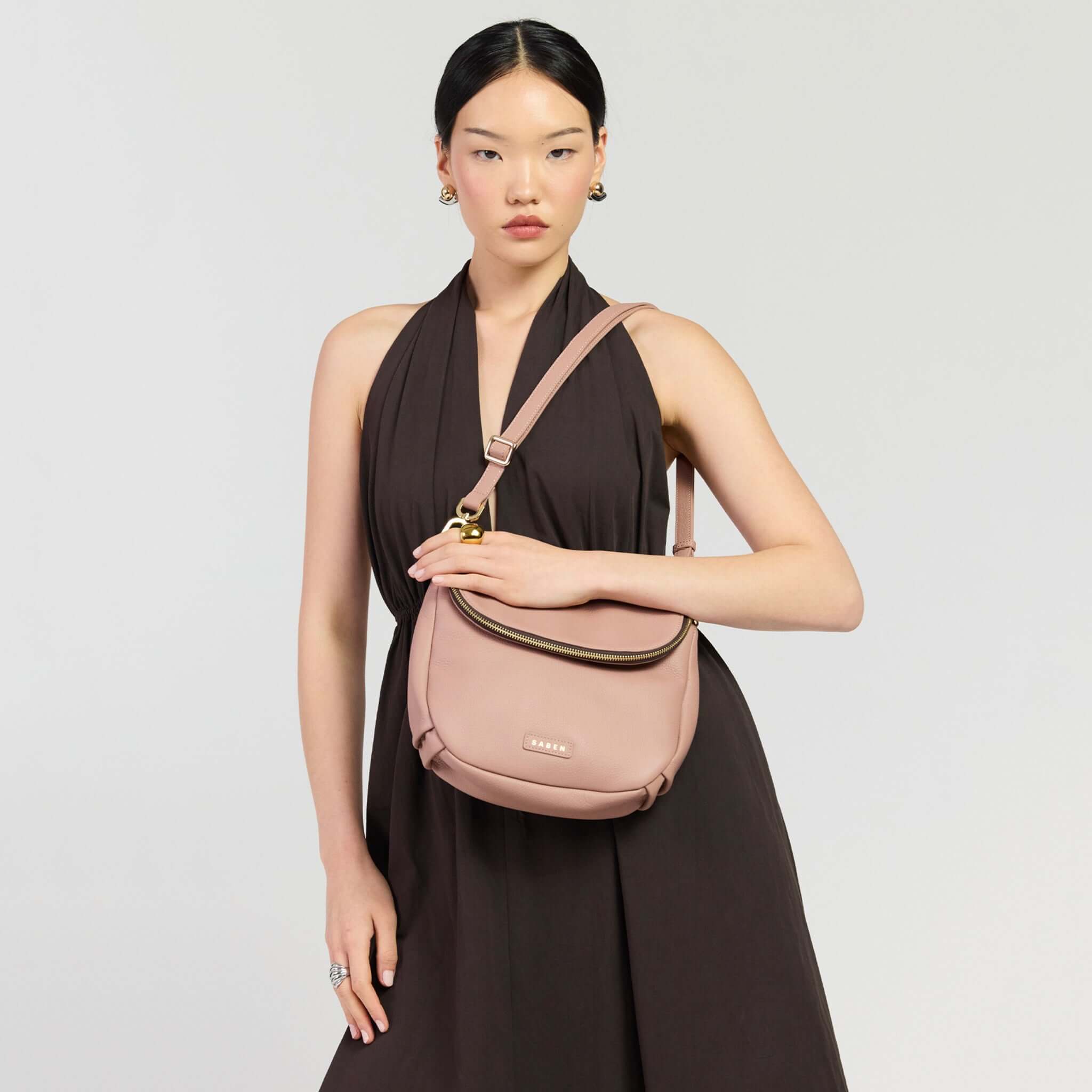 Saben Fifi Crossbody Bag - Rosewater, compact and chic, showcased on model wearing a stylish dark dress.