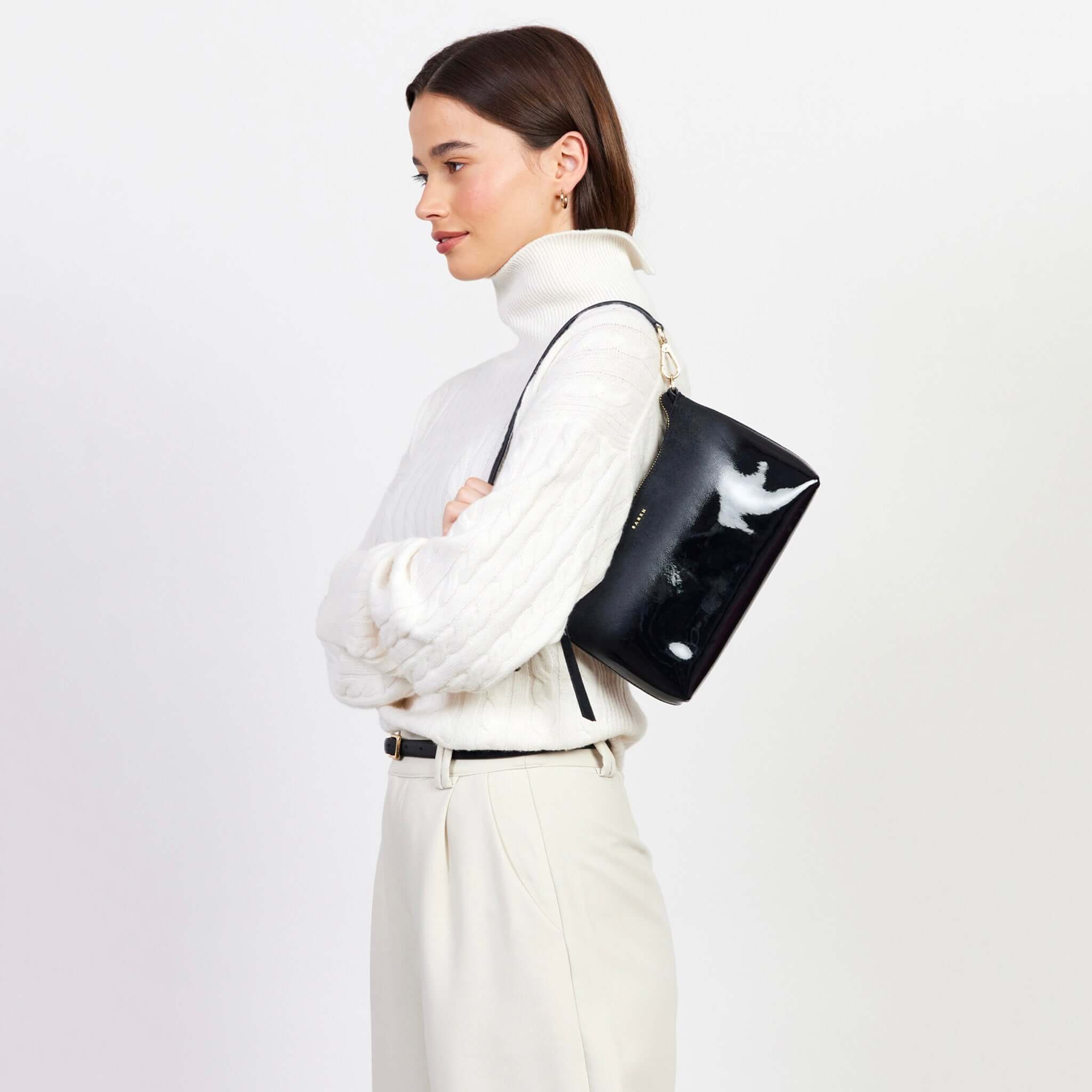 Saben Haven Shoulder Bag - Black Dipped worn on shoulder by model, glossy black compact evening bag with strap