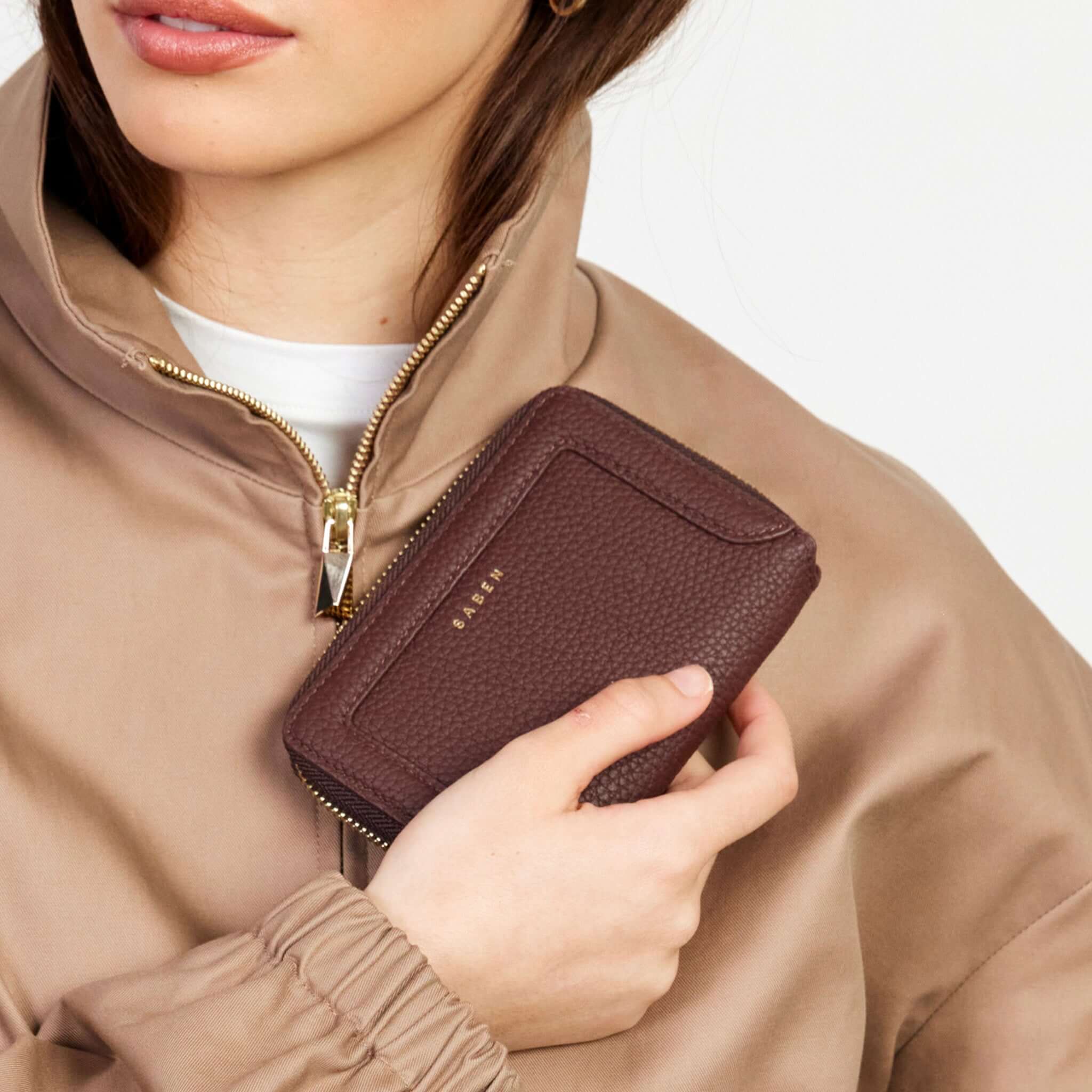 Alt Tag: Saben Landry Wallet - Espresso in premium espresso leather, zip-around wallet with card slots and coin pocket held in hand