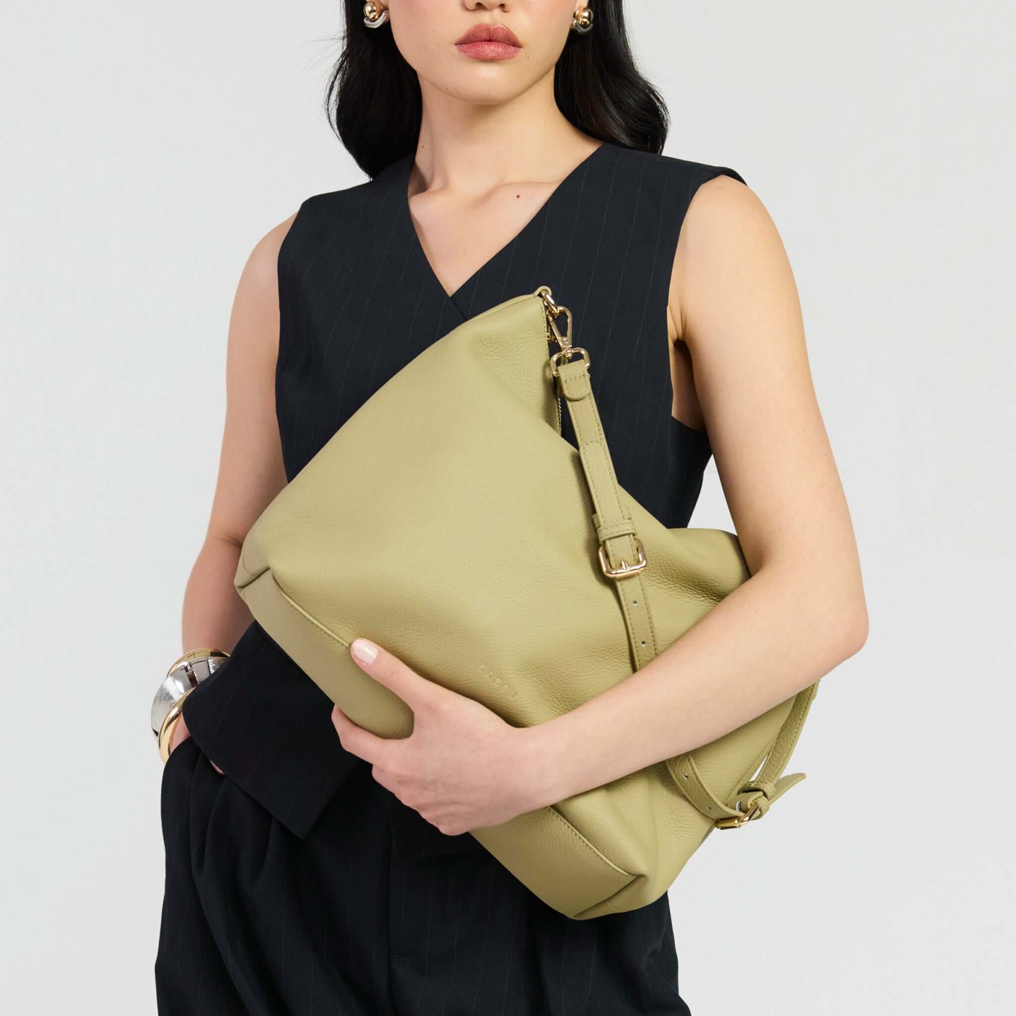 Saben Miki Shoulder Bag - Willow Luxe held stylishly by a model in a black outfit.