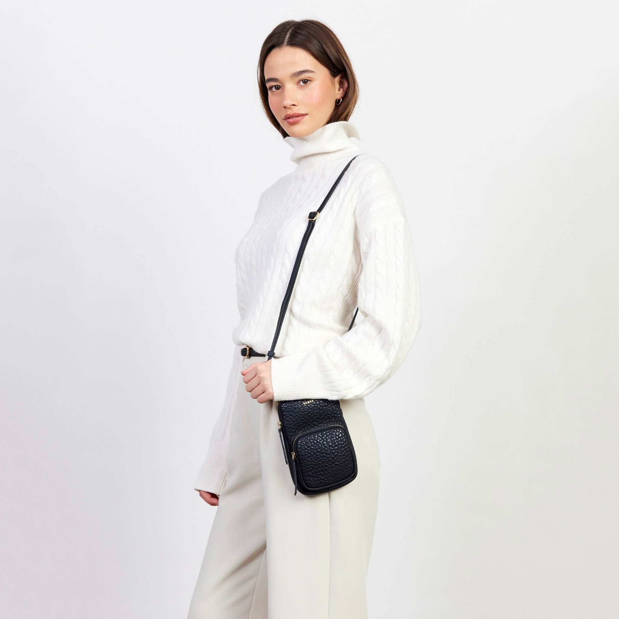 Saben Nikko Phone Sling - Black Bubble worn crossbody on model, wallet-sized phone sling with adjustable strap for essentials