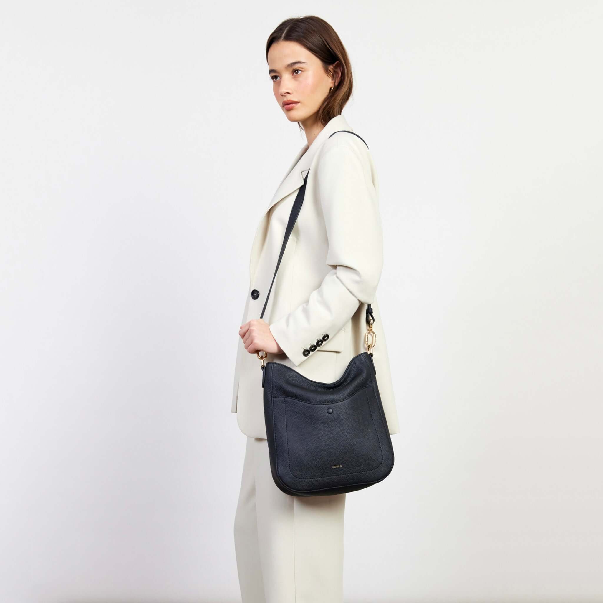 Alt Tag: Saben Rebe Shoulder Bag - Black Luxe on model, black pebbled leather hobo bag with detachable shoulder/crossbody strap