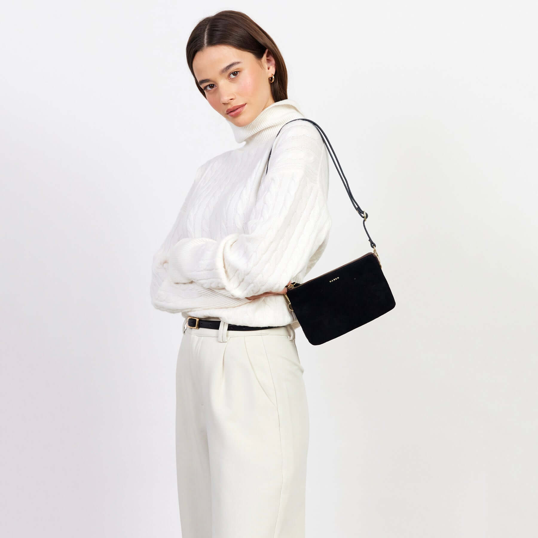 Alt Tag: Saben Tilly Crossbody Bag - Black Suede worn as a shoulder bag by model, sleek black suede leather crossbody