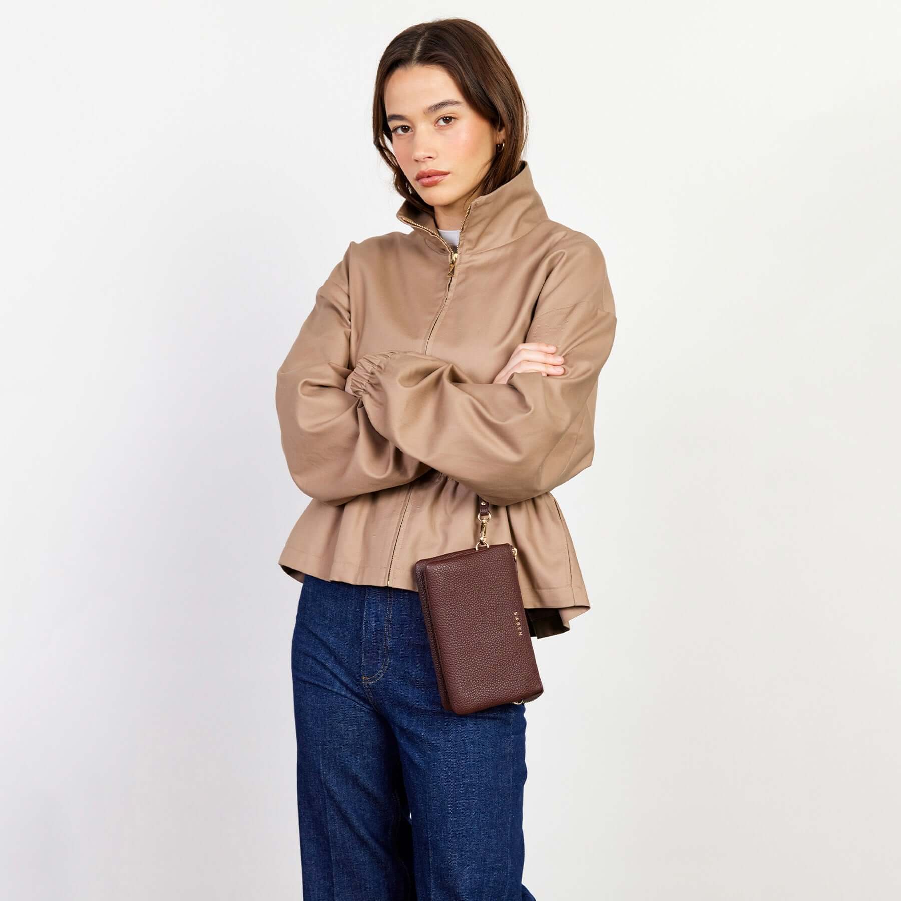 Alt Tag: Model wearing Saben Tilly Crossbody Bag - Espresso leather wallet clutch crossbody with chain strap