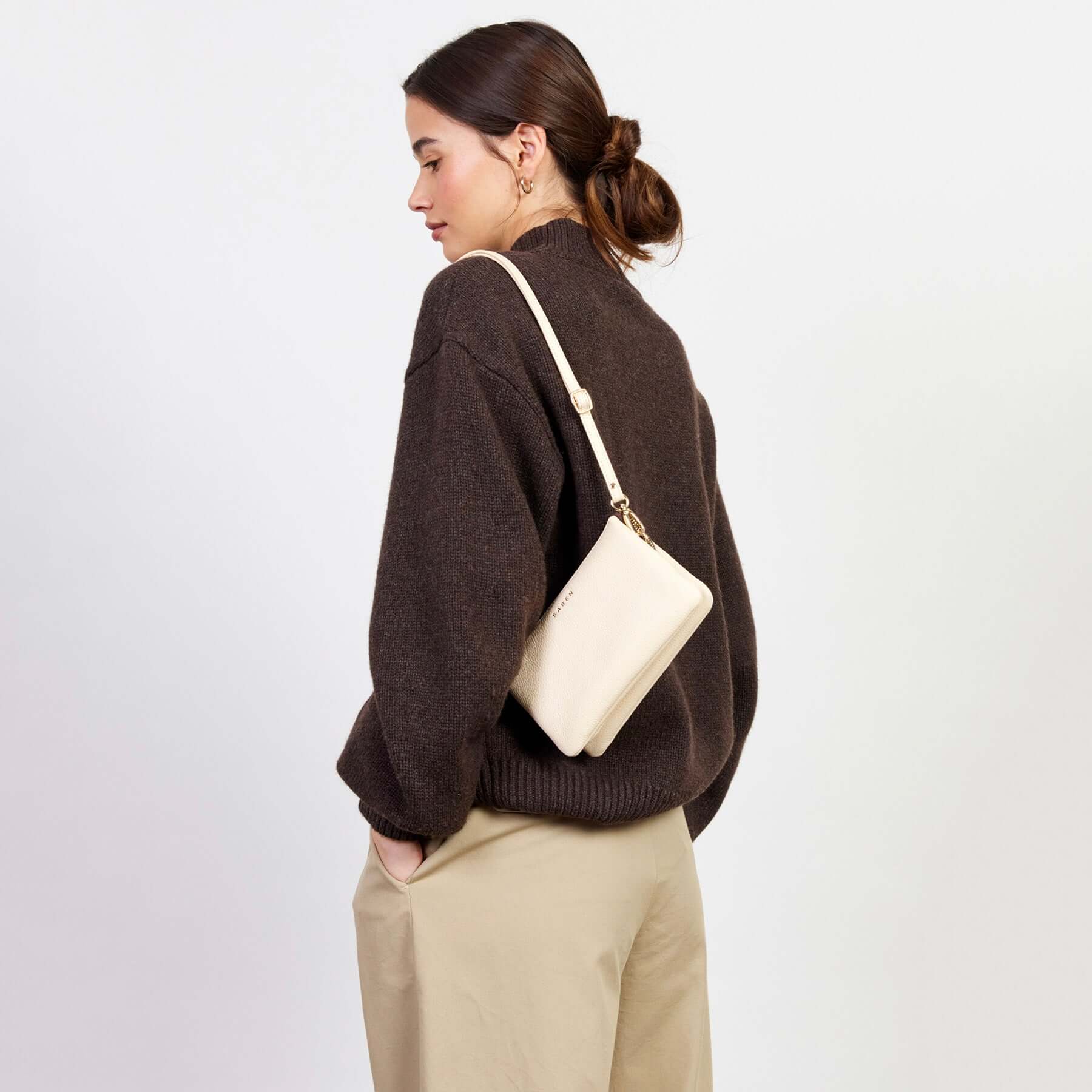 Alt Tag: Saben Tilly Crossbody Bag - Vanilla worn as crossbody, vanilla leather wallet clutch bag with adjustable strap