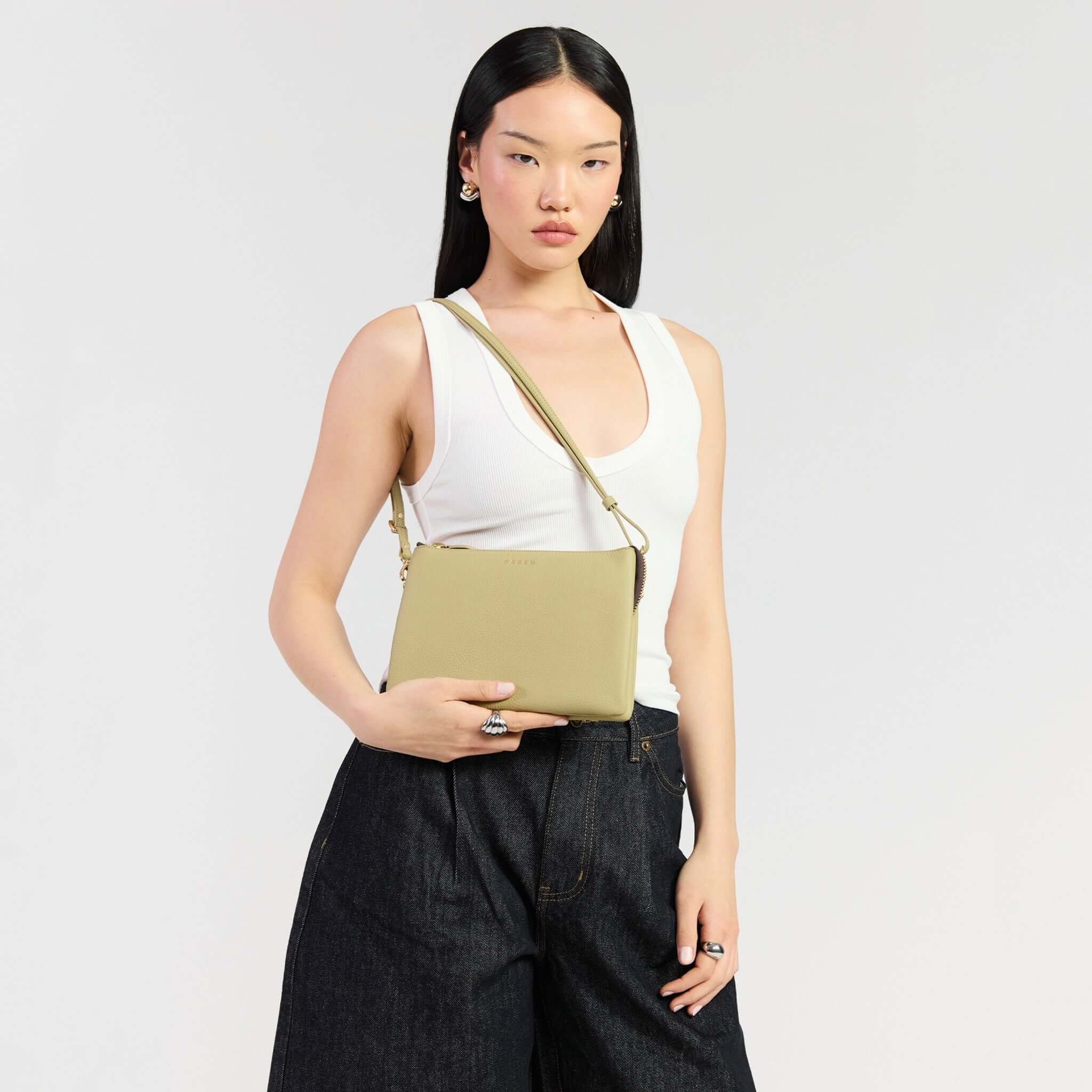Model showcasing Saben Tilly's Big Sis Crossbody Bag - Willow in olive green, perfect for work or weekends.