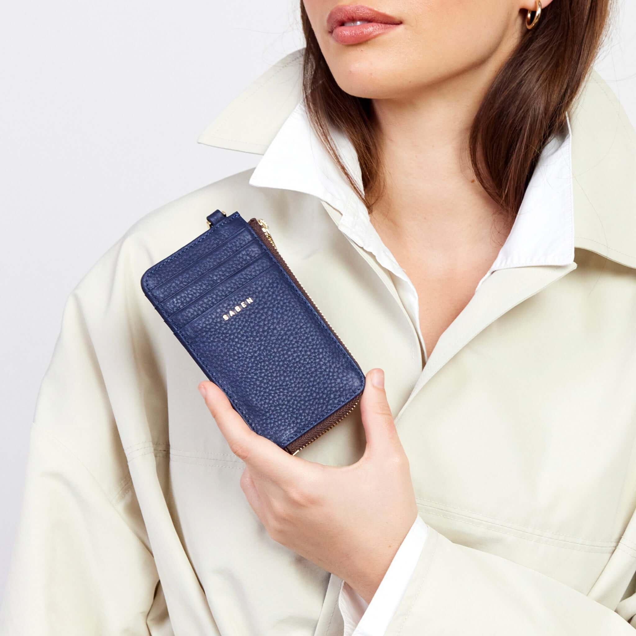 Saben Winona Card Holder - Ink held by a model, showcasing its sleek design and premium textured leather.