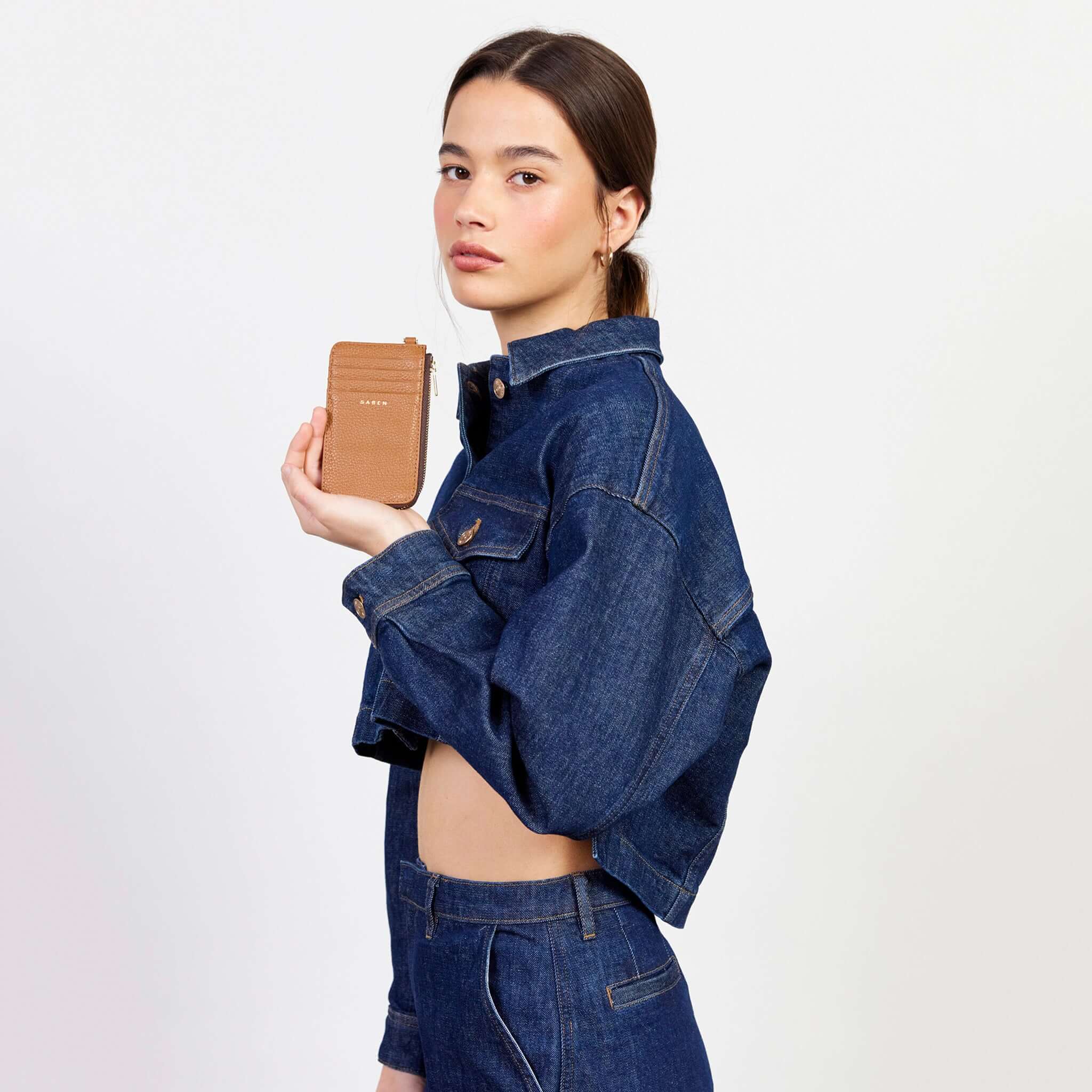 Saben Winona Card Holder - Toffee textured leather wallet with 8 card slots and zip coin compartment, held by model